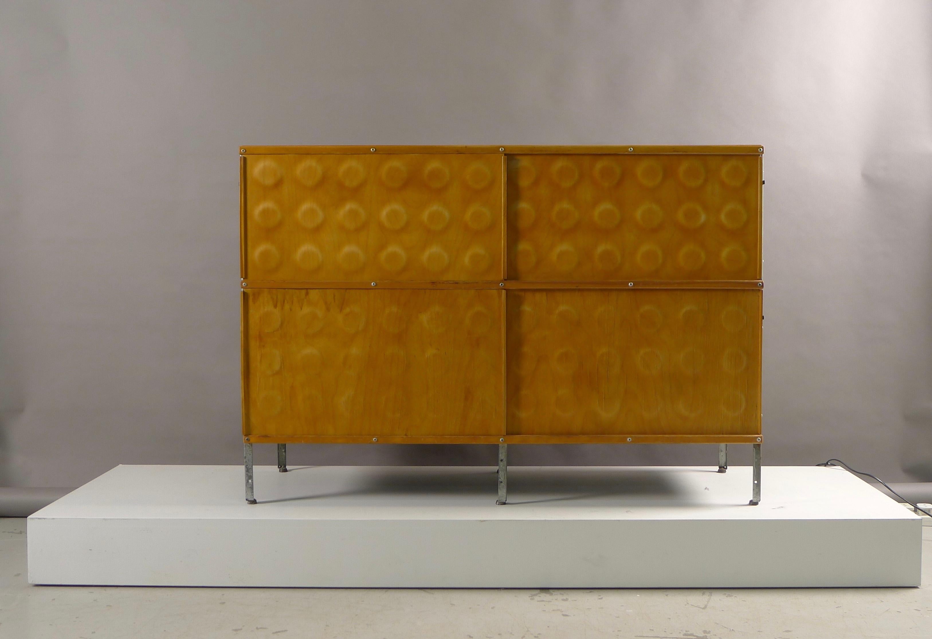 Charles and Ray Eames for Herman Miller, USA. From the 200 series of storage units, this 240-N features top and bottom pressed plywood dimple doors, plywood top with a nice honeyed patination. Zinc plated steel legs and masonite panels. Sides are