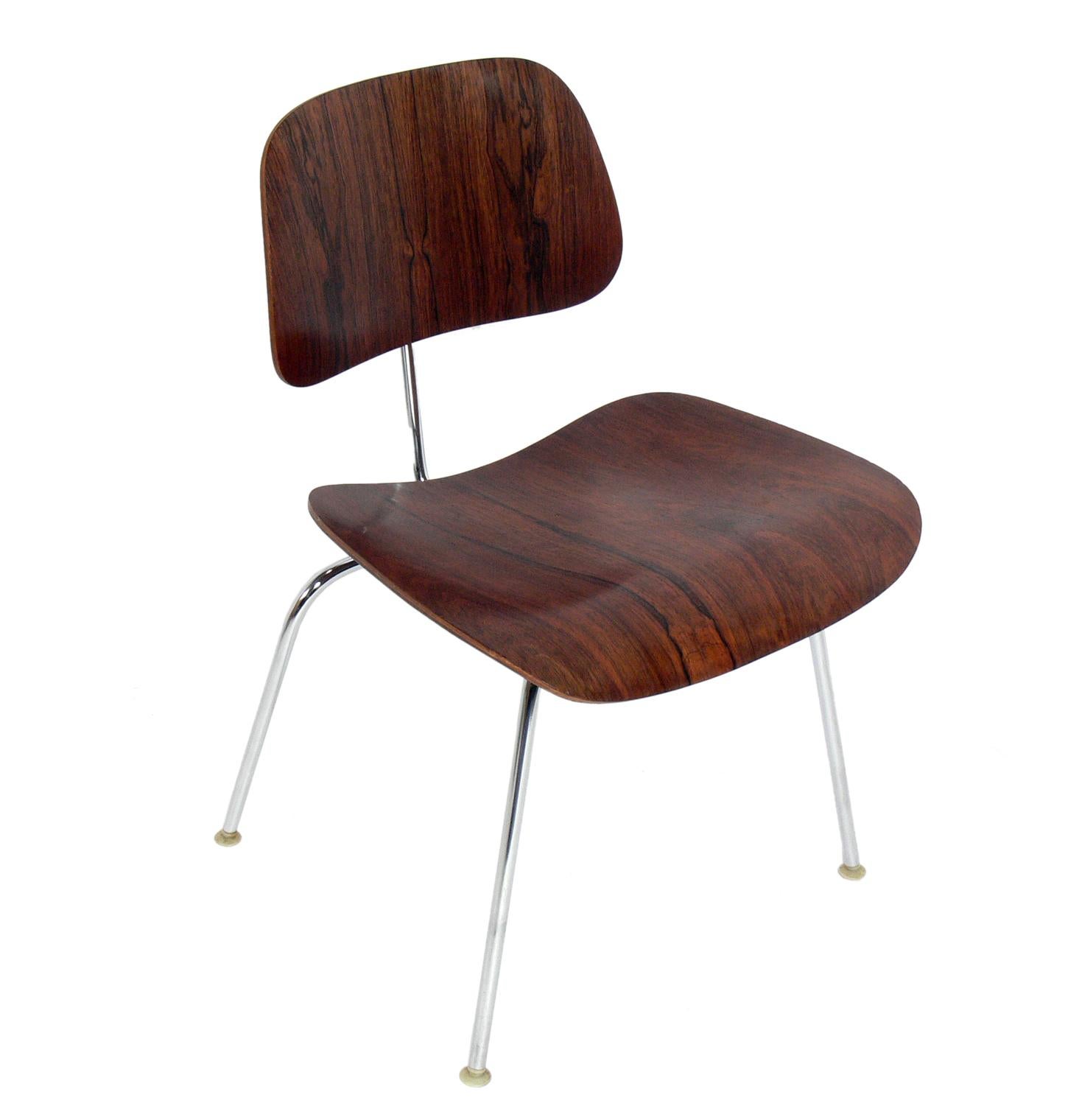 Hard To Find In Rosewood DCM (Dining Chair Metal) Chairs, designed by Charles and Ray Eames for Herman Miller, circa 1960s. Beautiful graining to the rosewood. They are priced at $1200 each or $2200 for the pair. They are a versatile size and can be