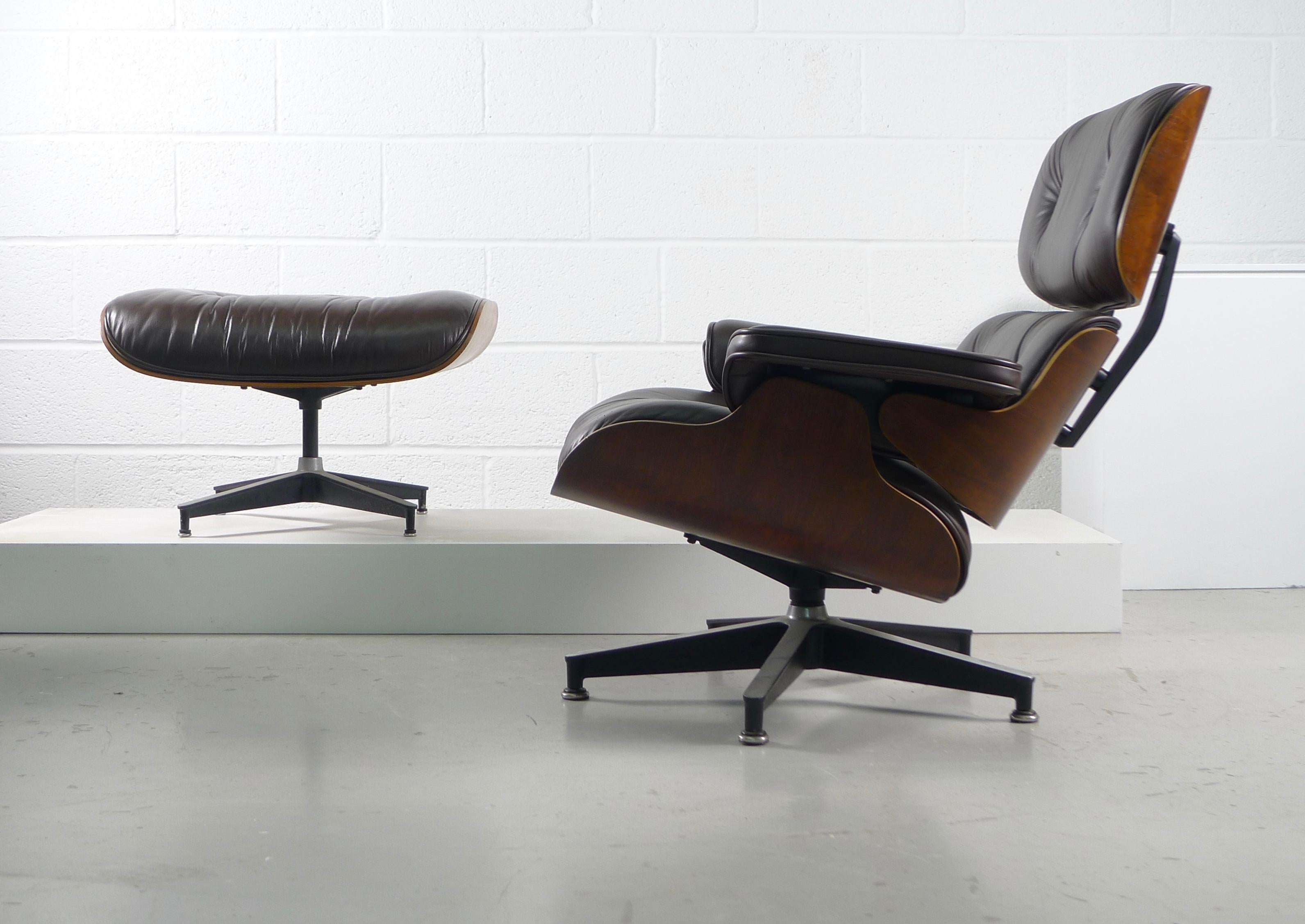 Charles and Ray Eames model 670/671 lounge chair and ottoman for Herman Miller USA, 1956. 

Rosewood shells and dark chocolate brown leather, this example from the 1970s. Multiple labels to both chair and stool. 

Possible free delivery to