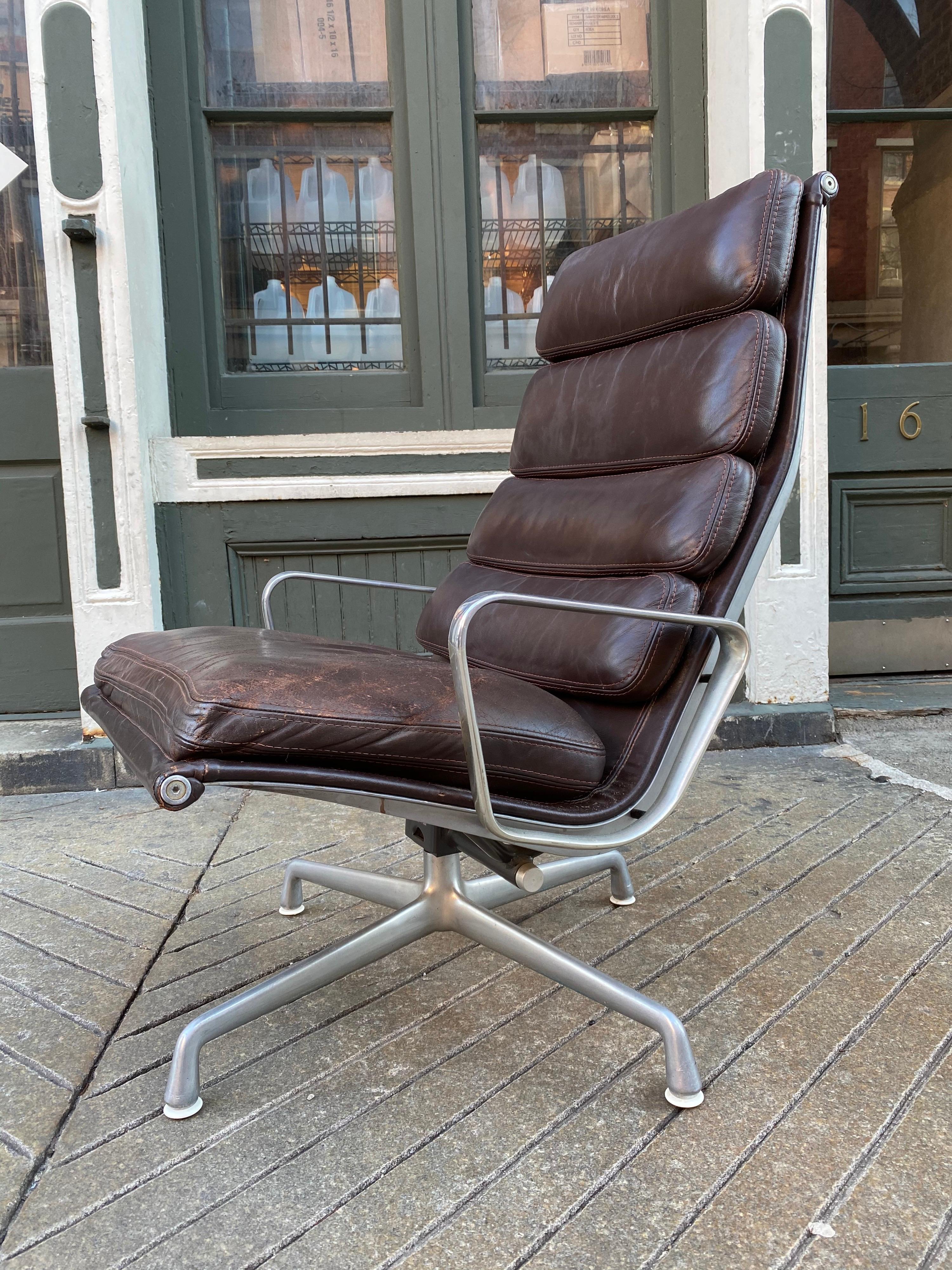 Eames soft pad lounge chair in brown leather for Herman Miller. Chair is about 25 years old and shows wear as seen in the photos. Seat area has some roughness to the leather. Wear marks to edges or corners. I had new foam put in the seat cushion.