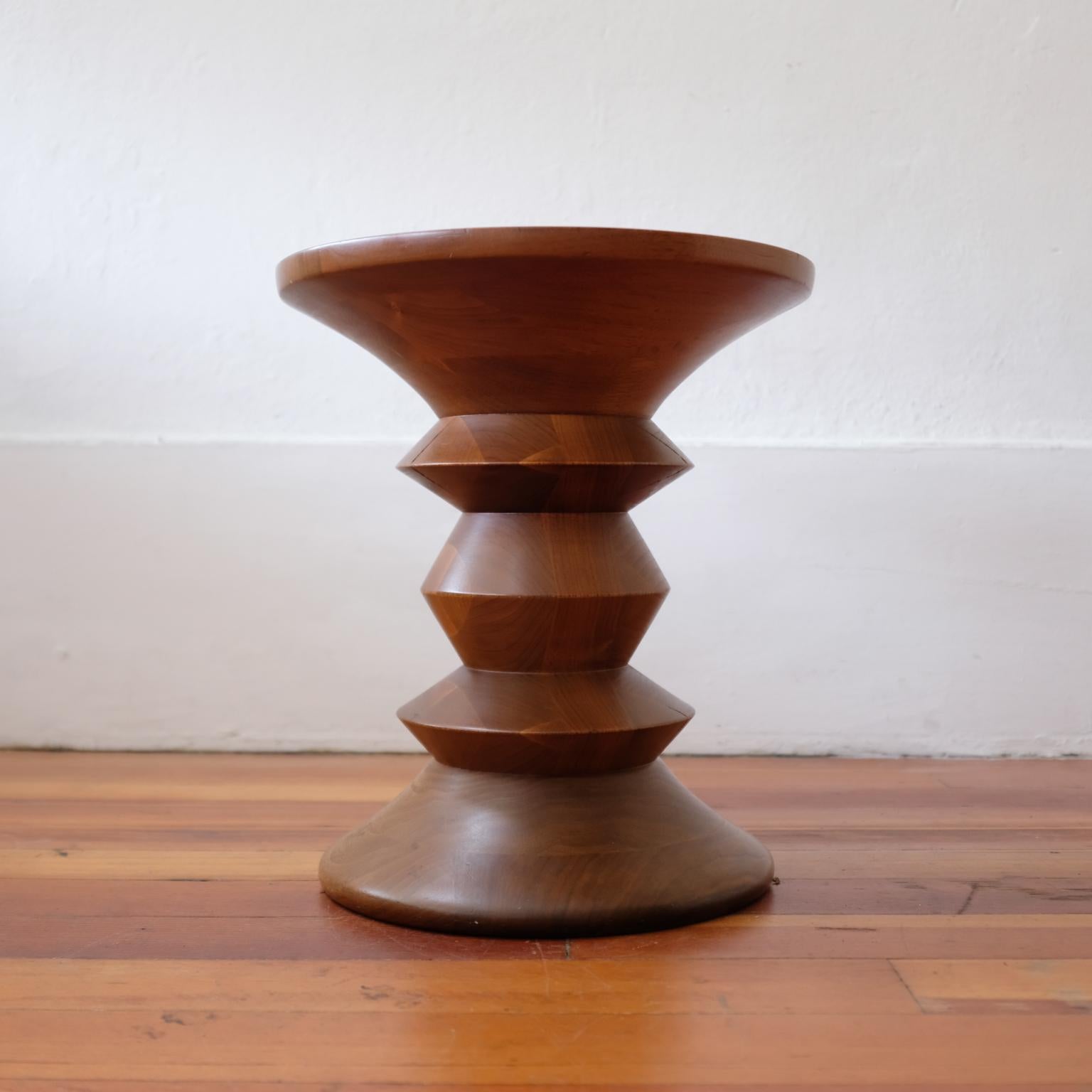 Time Life stool or table by Charles and Ray Eames. This is shape C in solid walnut. The design was originally created for the lobby and executive suites of the Time-Life Building at Rockefeller Center in New York City. Produced by Herman Miller,