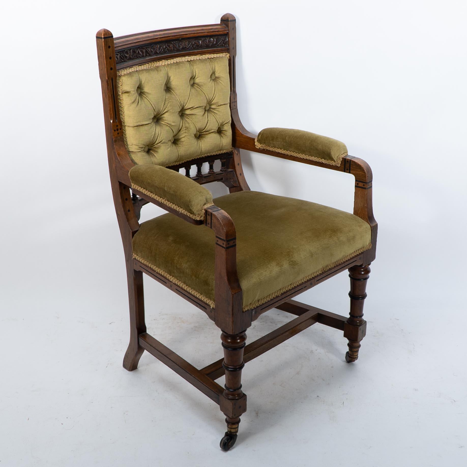 Charles Bevan for Marsh Jones and Cribb, attributed. A good quality set of six Gothic Revival oak dining chairs with geometric dot and line ebonized inlay and finely carved leaf and berry decoration to the head rails, consisting of an armchair and