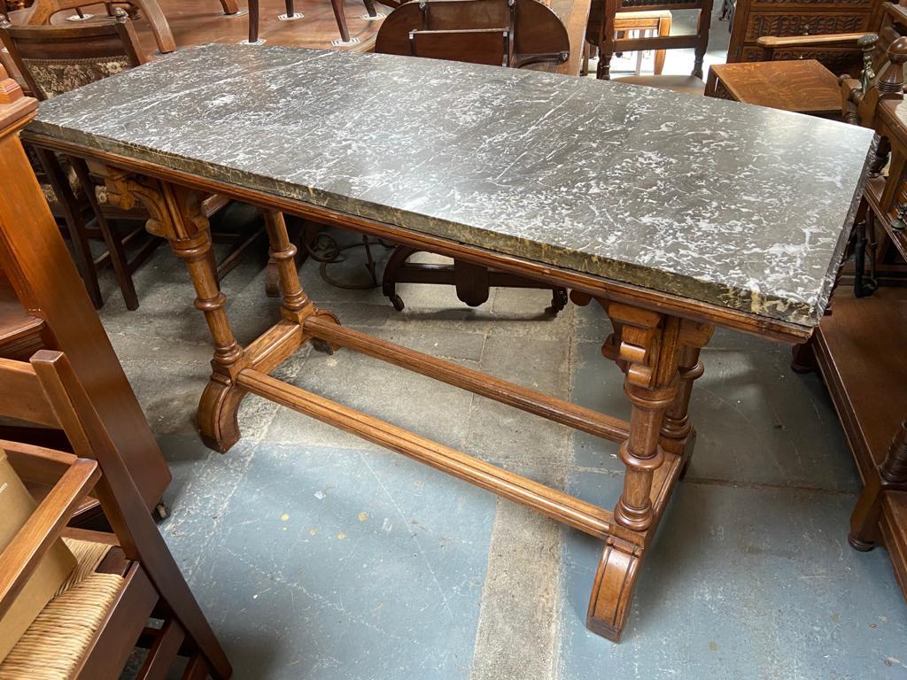 Charles Bevan, attri. probably made by Marsh Jones and Cribb of Leeds.
A super quality Gothic Revival oak library or Sofa table with semi-circular veined marble top, arched supports below with subtle carved floral details above four turned legs