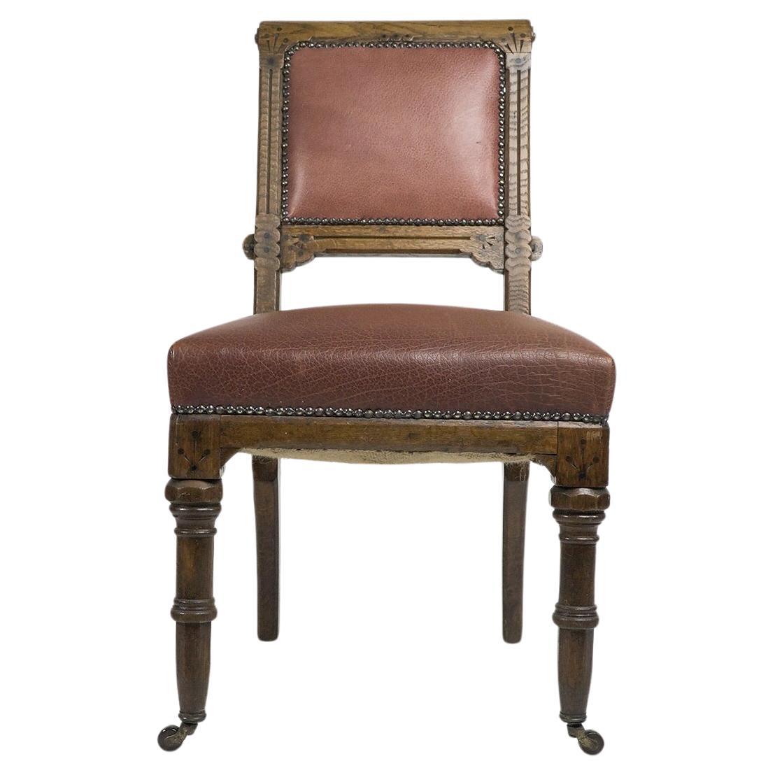 Charles Bevan attributed. A gothic Revival side chair with scroll carvings to the upper sides and incised decoration framing the backrest, with chamfered, and carved, and dot decoration, and again to the front seat corners. The ring turned legs have