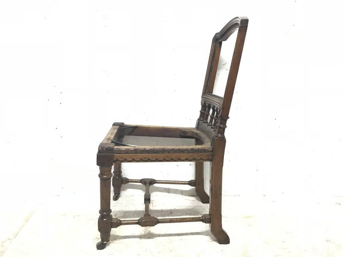 Charles Bevan attributed, probably made by Marsh and Jones of Leeds.
A fine quality Gothic Revival oak desk or side chair with turned uprights below the backrest and carved wavy details below the seat. Turned front legs on original brass casters,