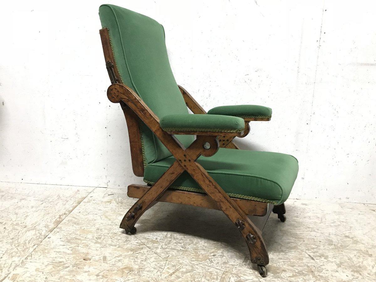 Charles Bevan under licence to Marsh Jones & Cribb. A 'New Registered Reclining Chair'.
A Gothic Revival reclining upholstered arm chair, with pegged oak frame and original casters.
The brass mechanism is in great shape still works
