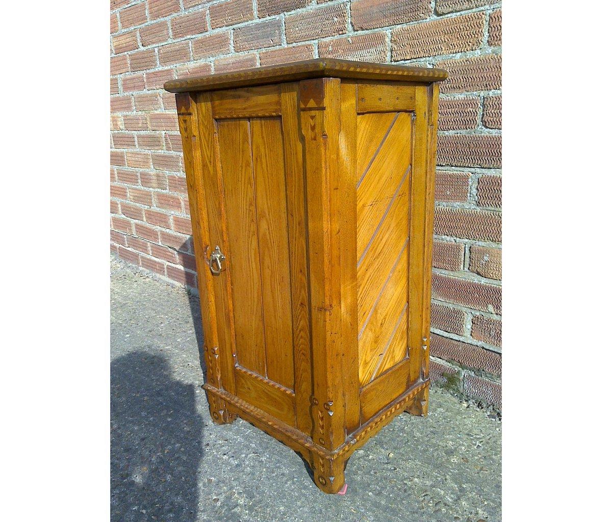 Charles Bevan In the style of.
A Gothic Revival oak bedside cupboard with chevron inlaid details throughout and 45 degree planking to the sides.