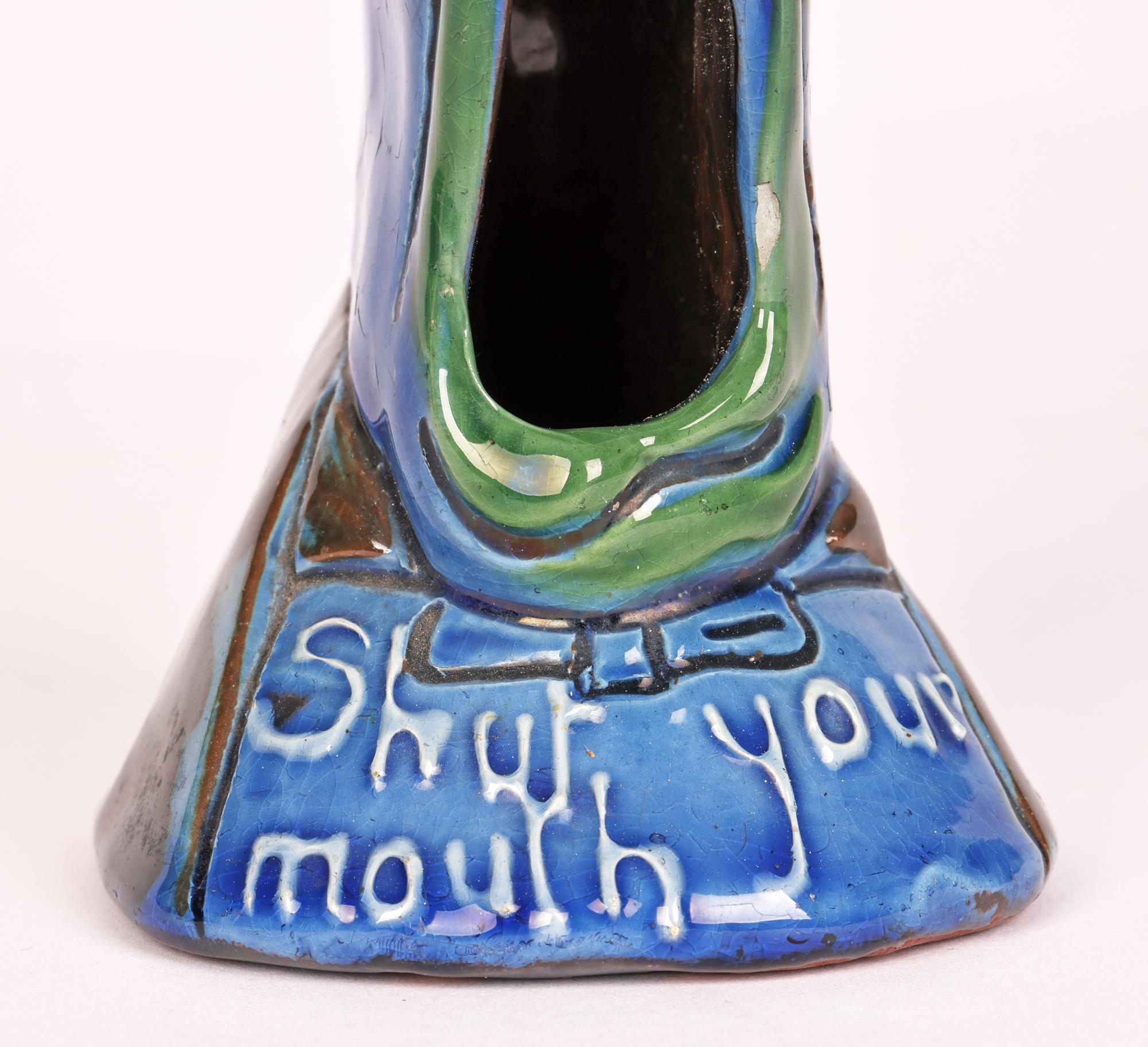 A very unusual grotesque sgraffito pattern hat pin holder titled ‘Shut your mouth’ and dating from the latter 1880’s. 

The Brannam pottery was started by Thomas Brannam in Barnstaple, Devon in 1848. In 1862 his son Charles Hubert Brannam (aged 12)