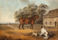 A Bay cob, spaniel and a pug outside a stable