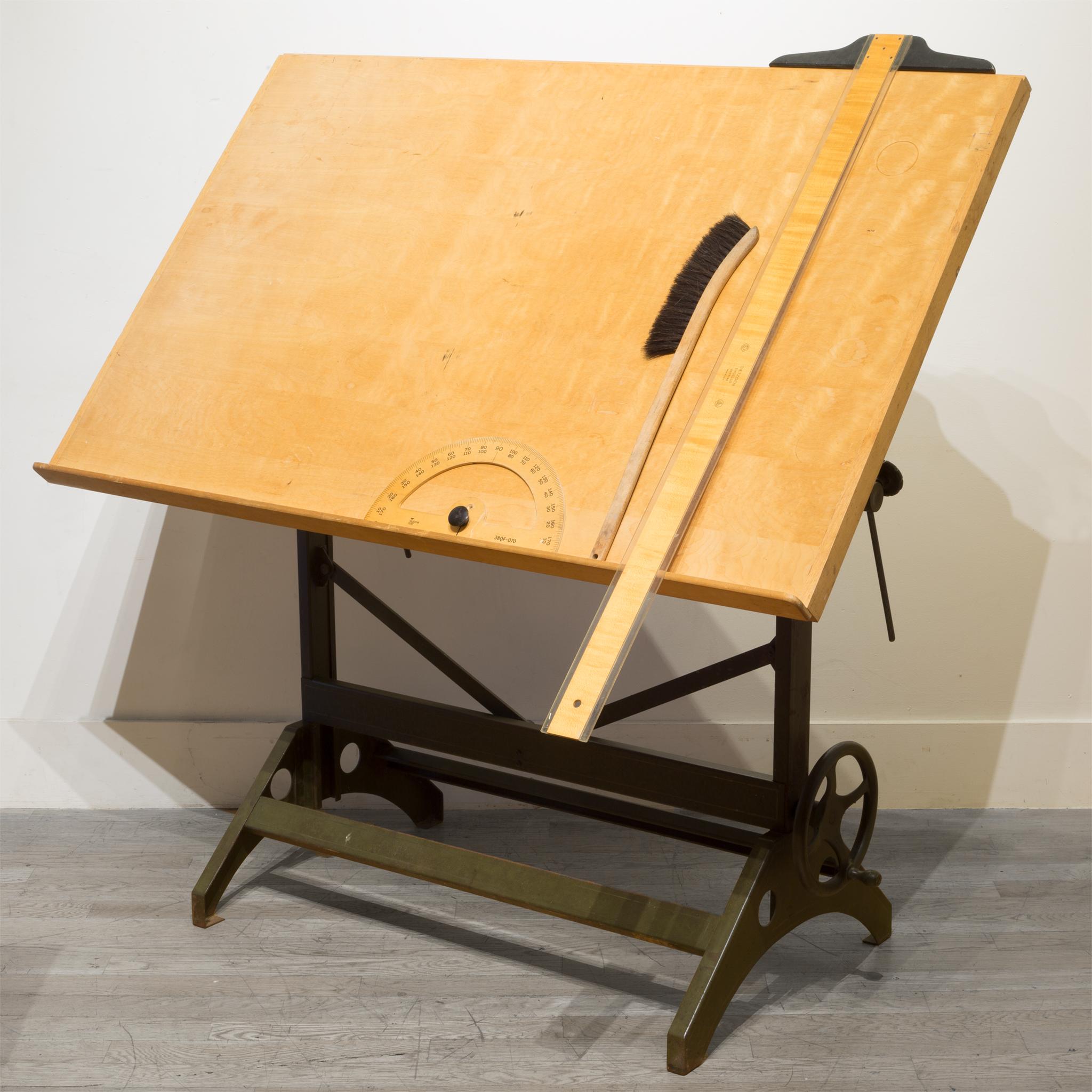 About

This is an industrial steel drafting table with the original wooden top and large handle on the side. The table is an Army green with gold stripes. The angle of the top and the height are both adjustable for use as a dining table or as a