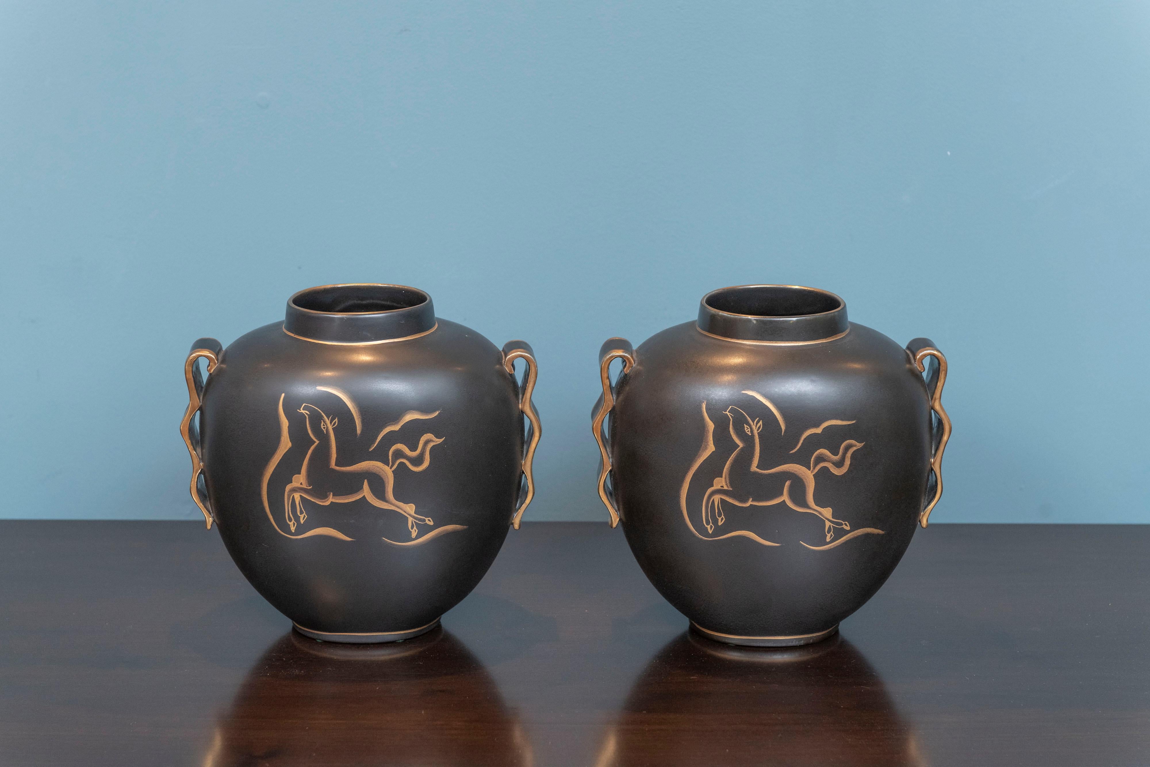 Charles Catteau Art Deco vases for Boch Freres Keramis Belgium. Written on each base D. 2447, 1291. Gilt hand painted horse on one side and stylized tulip on back, wave handles with gilt edges and gilt trim on top and around base. Listed in 'Art