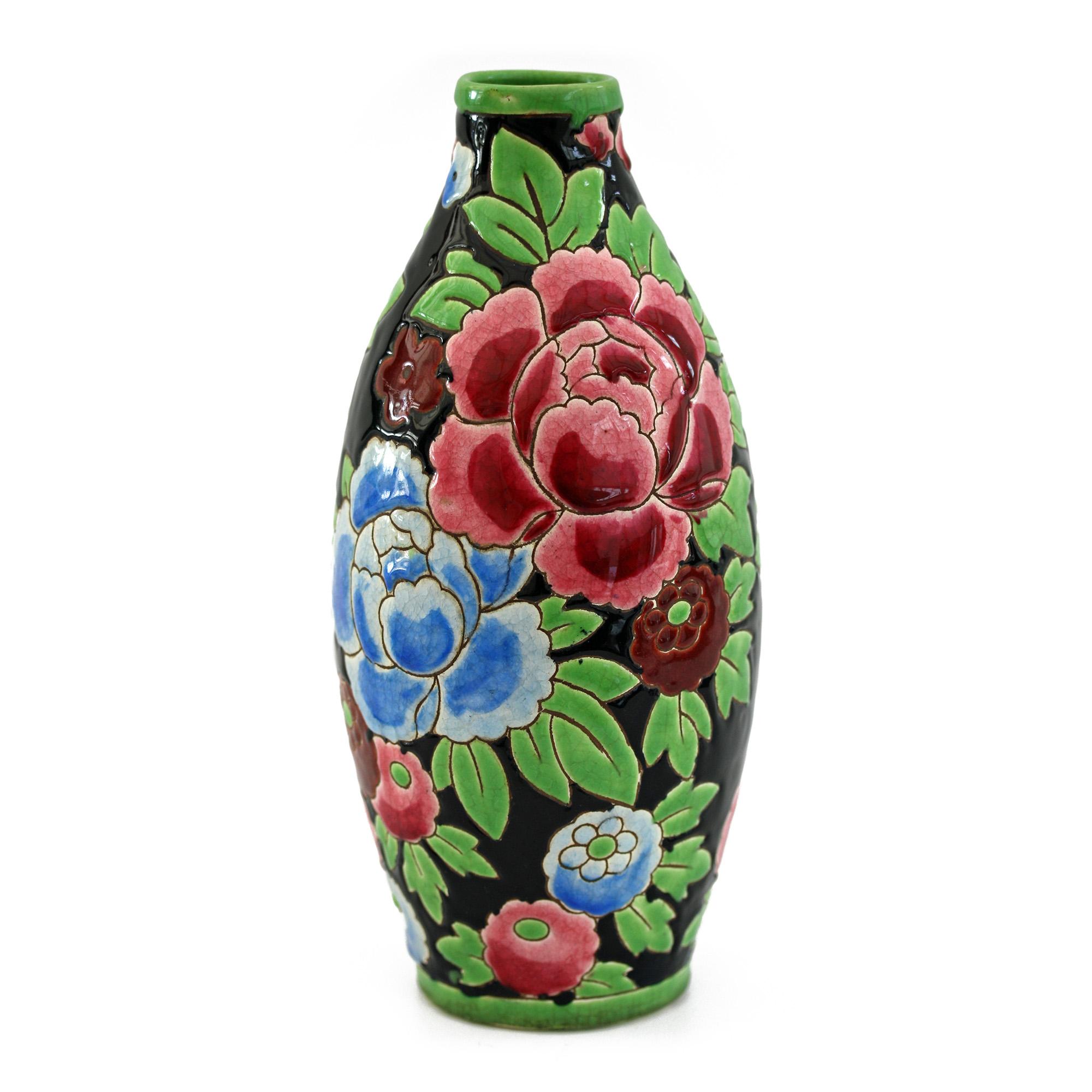 Stunning Belgian Art Deco Boch Freres Keramis art pottery vase decorated with red and blue peonies designed by Charles Catteau. The lightly potted vase of tall bulbous shape is finely incised and hand painted in bold colors with large peony blooms