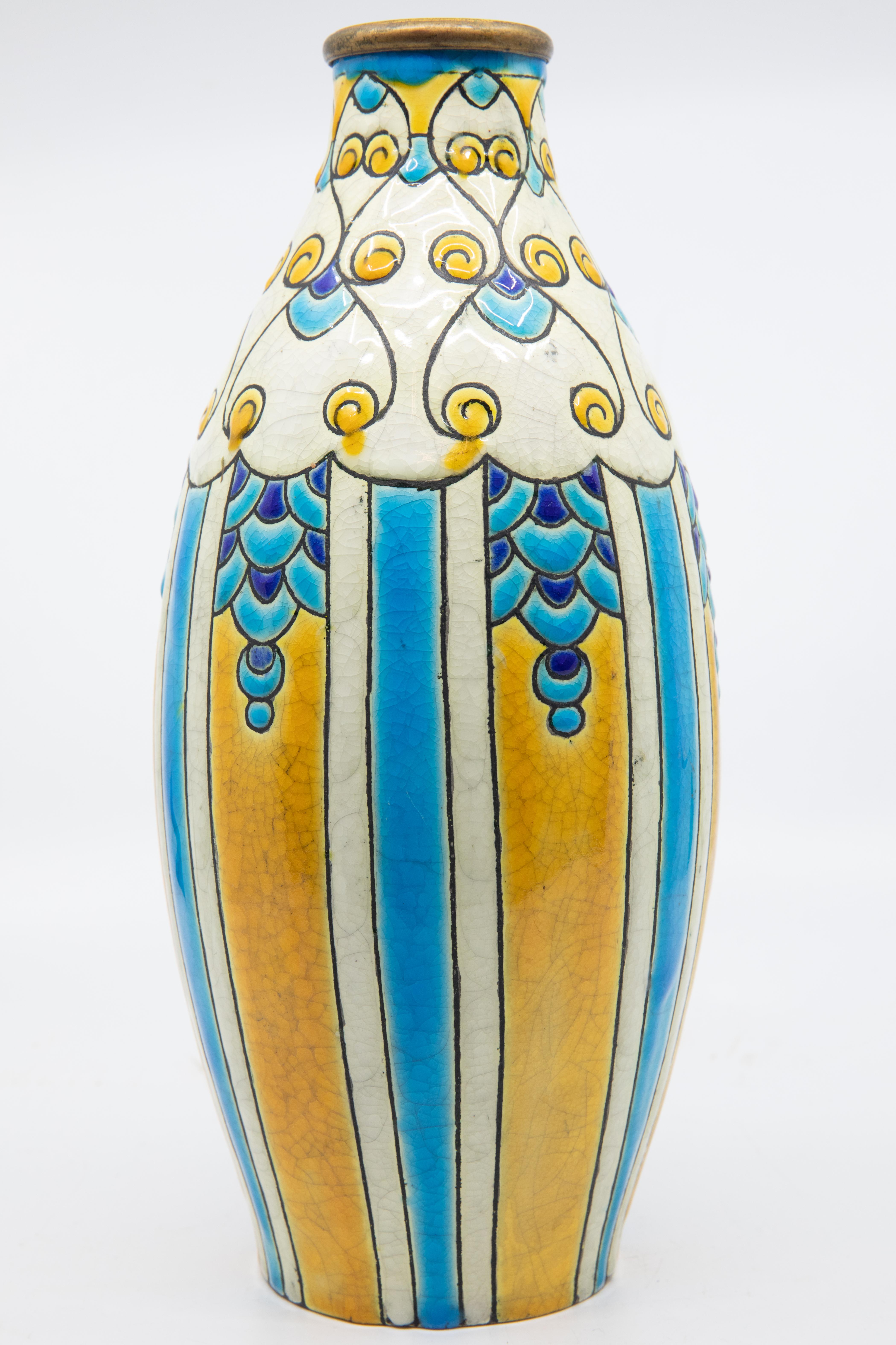 Charles Catteau for Boch Freres enameled Art Deco ceramic vase circa 1924. Charles Catteau Born at Douai, Charles Catteau trained at the National Ceramics School in Sèvres. In 1904, Catteau was hired by the German Nymphenburg Porcelain Factory, near