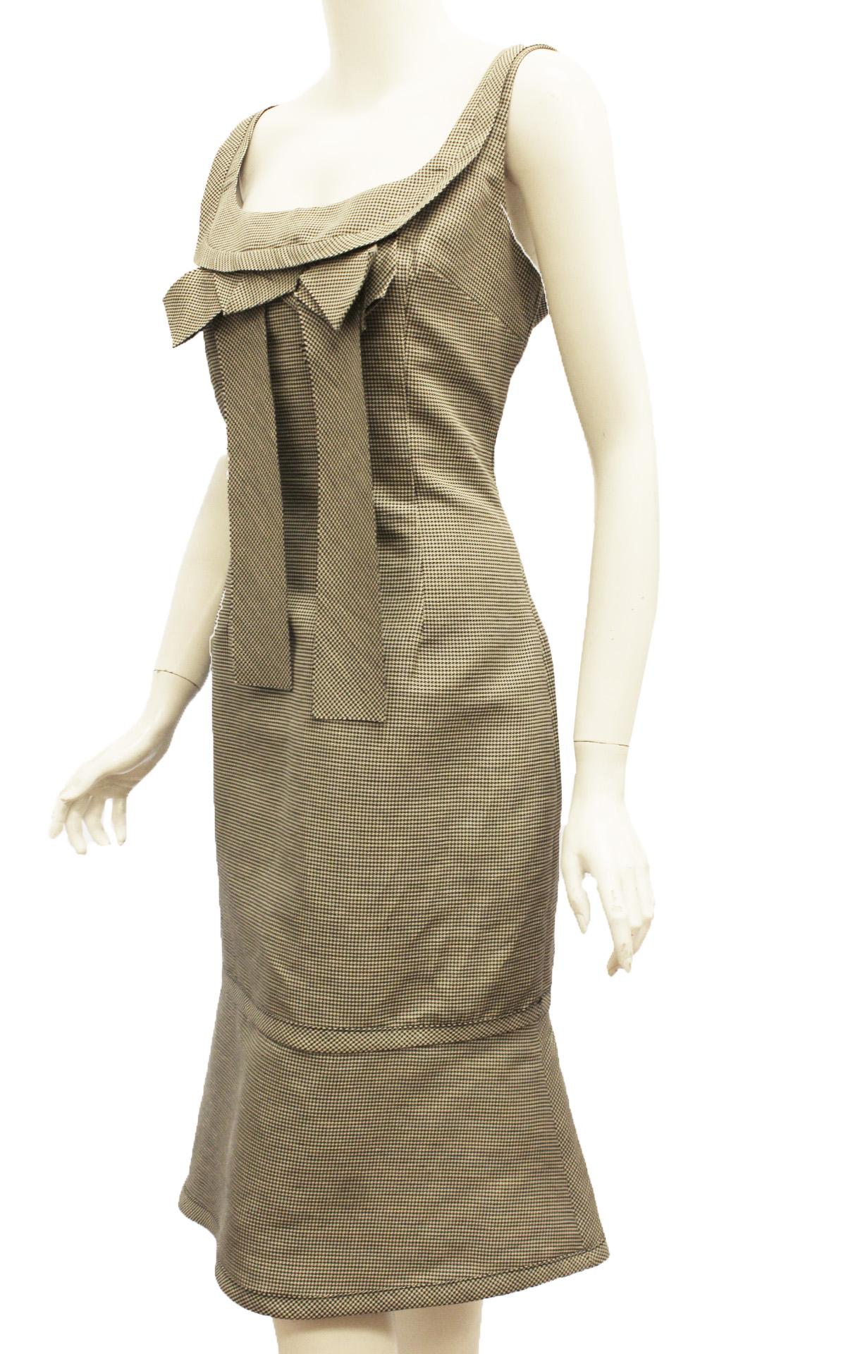 Charles Chang-Lima black and white check linen and silk sleeveless dress contains a decorative flat bow at front around neckline that falls to the waist.  For closure a hidden back zipper.  At the back, a pleated vent is located on the wide hem.