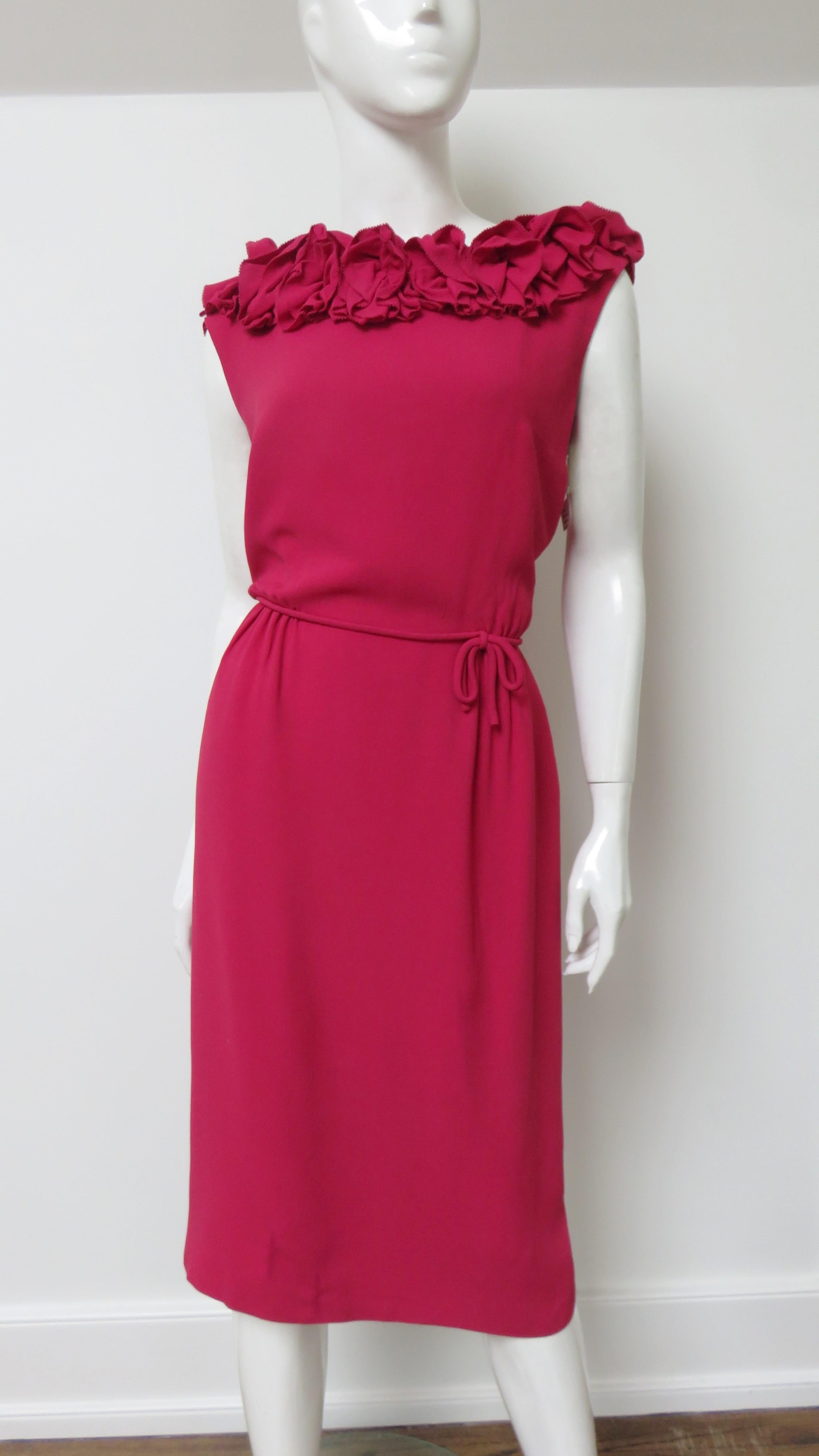 A pretty rose silk dress by Charles Cooper.  It is sleeveless with applique flowers around the neckline and low back.  It has a straight skirt, small piped belt, back zipper and it is fully lined.
Fits sizes Small, Medium.

Bust  36