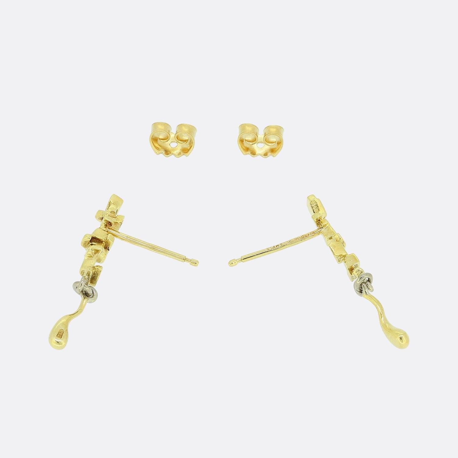 This is a wonderful pair of earrings from the luxury jewellery designer Charles de Temple. The earrings feature an abstract design which leads down to a drop that can move freely below. They are crafted in 18ct yellow gold with three white gold