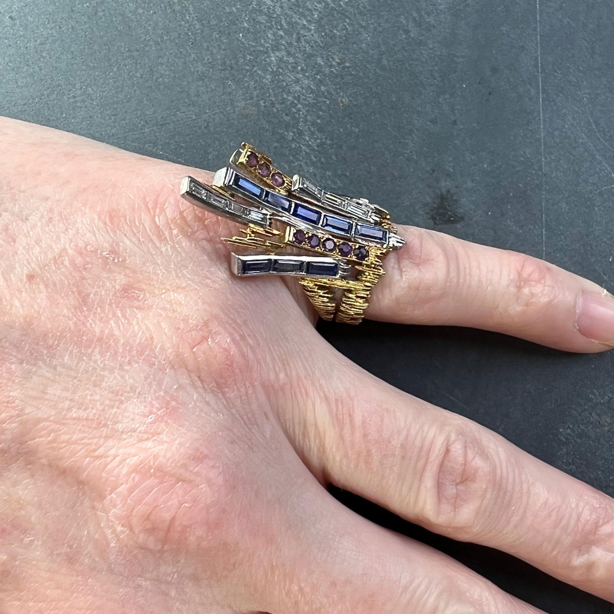 An 18 karat (18K) yellow and white gold pinky ring designed as a spray of gem-set lines extending from a textured yellow and white gold band. Hallmarked for 18K gold, London, 1965 with makers mark CdeT for Charles de Temple. 

Total approximate gem