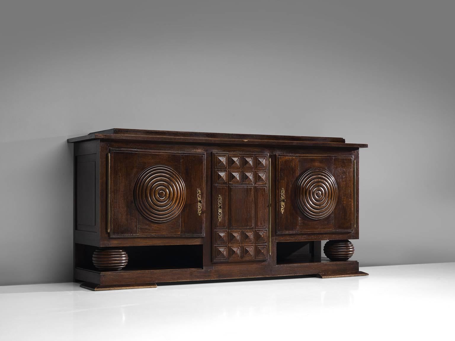 Charles Dudouyt, credenza, wood, circa 1925.

This sturdy credenza in oak with cilinder wood work is a truly sculptural piece. This two-door sideboard is equipped with several shelves and drawers which provide plenty of storage space. The