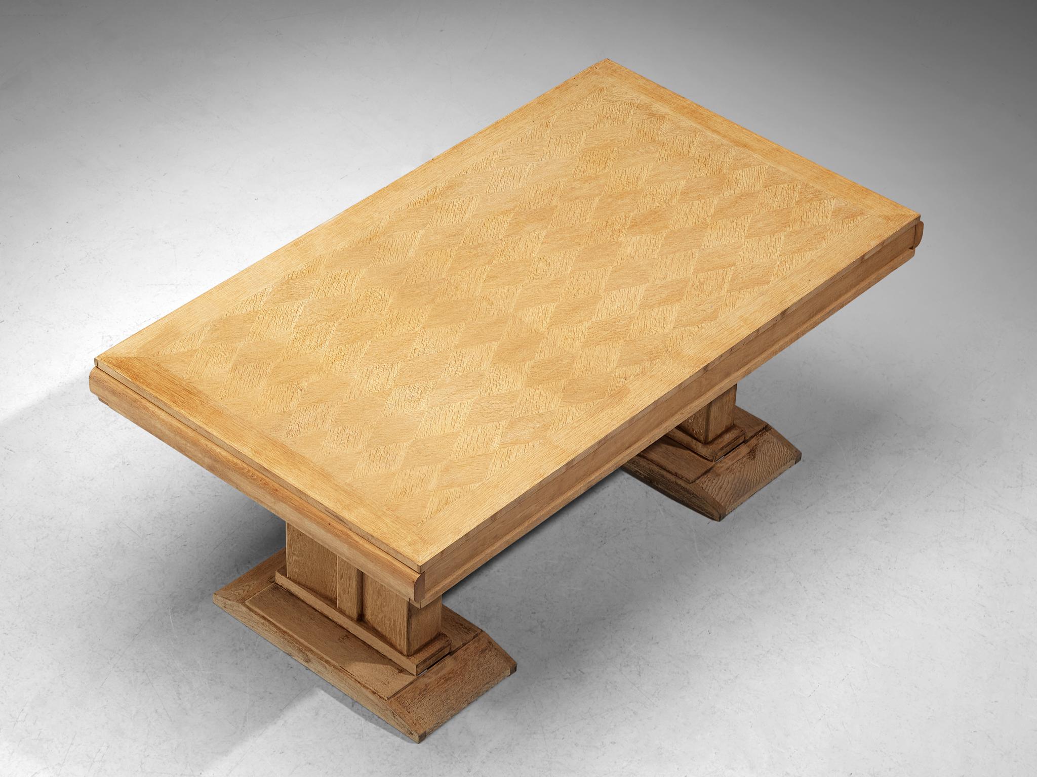 Charles Dudouyt table, cerused oak, 1940s, France. 

Dining table is designed by Charles Dudouyt. As many of his designs, this table has a strong and bold character in both the base and top. It features a geometric pattern on the top. The trestle