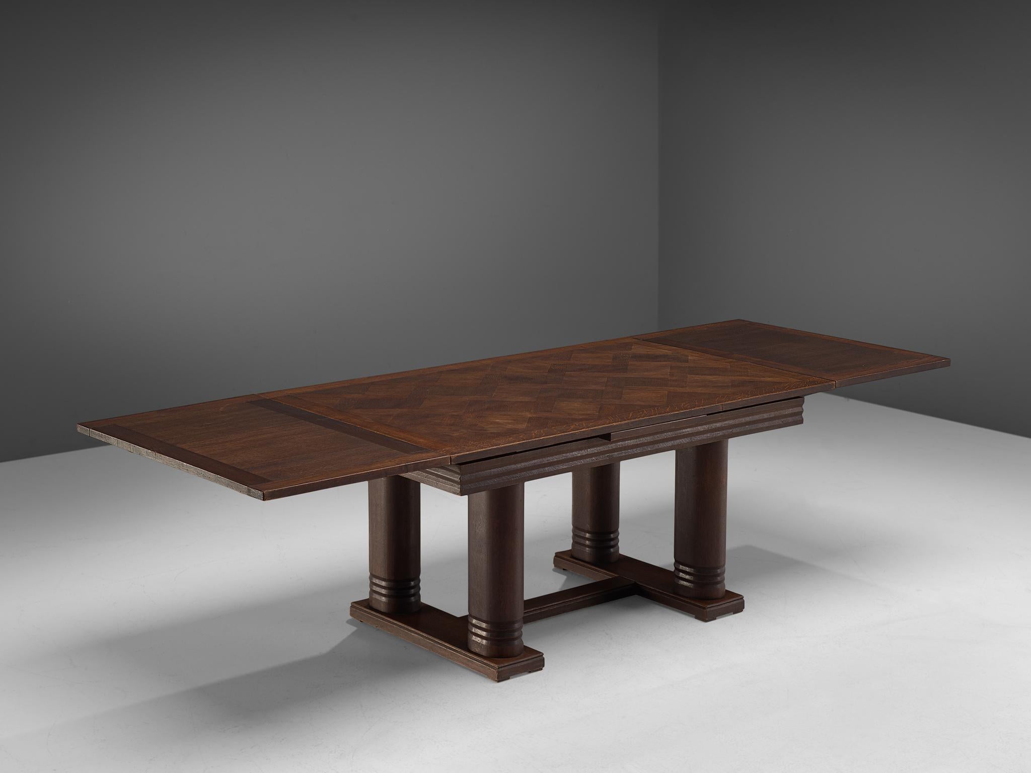 Charles Dudouyt, dining table, oak, France, 1940s.

This Art Deco table shows the great craftsmanship of Charles Dudouyt. The tabletop in inlayed with different pieces of wood, creating a beautiful pattern thanks to the different drawings. The base