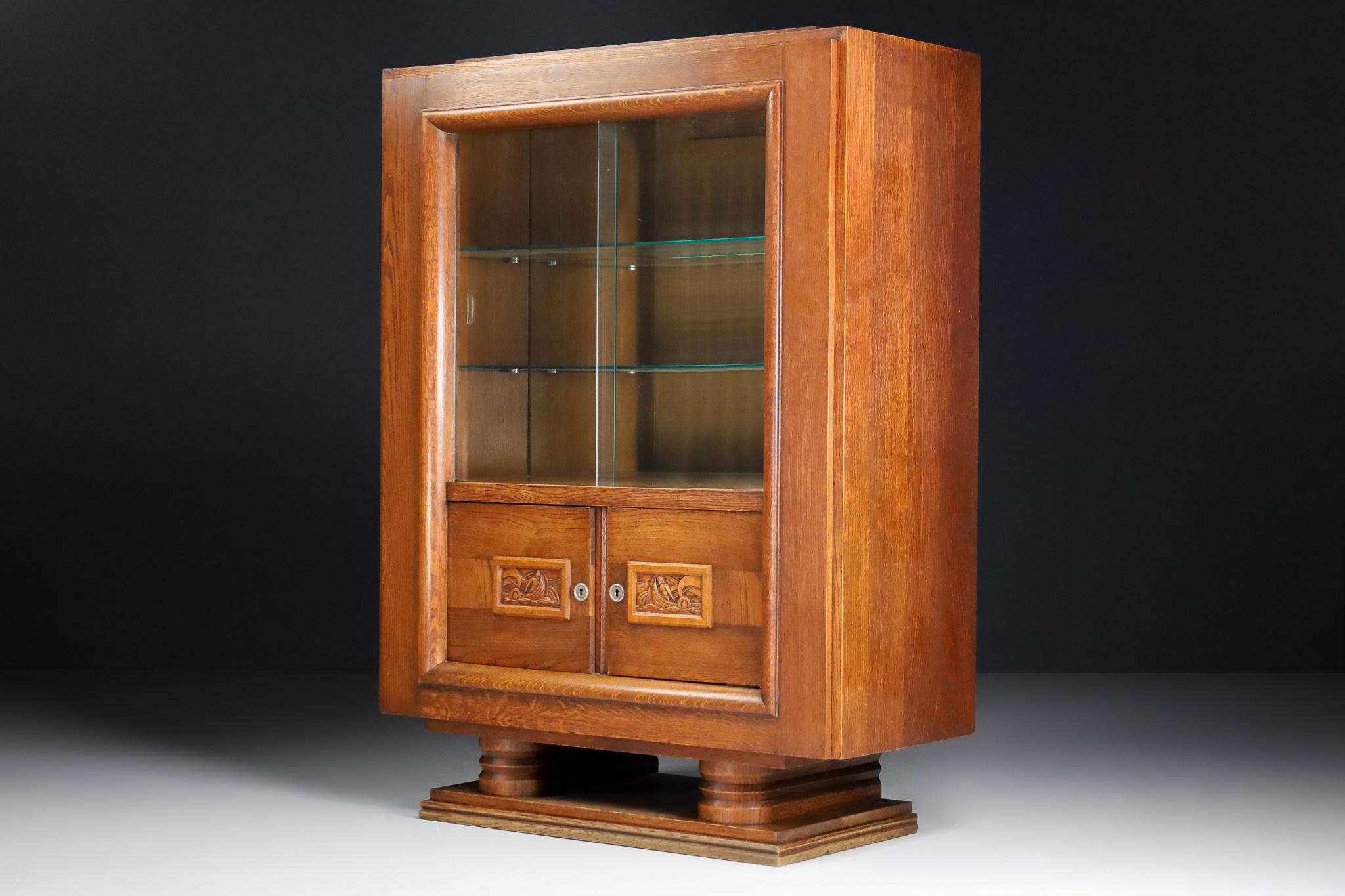 Art Deco glazed cabinet in oak by Charles Dudouyt, France 1940

This stunning Art Deco cabinet is made in Normandy, France, circa 1940. It is made from oak and is in excellent original condition with a lovely patina. This cabinet would be an