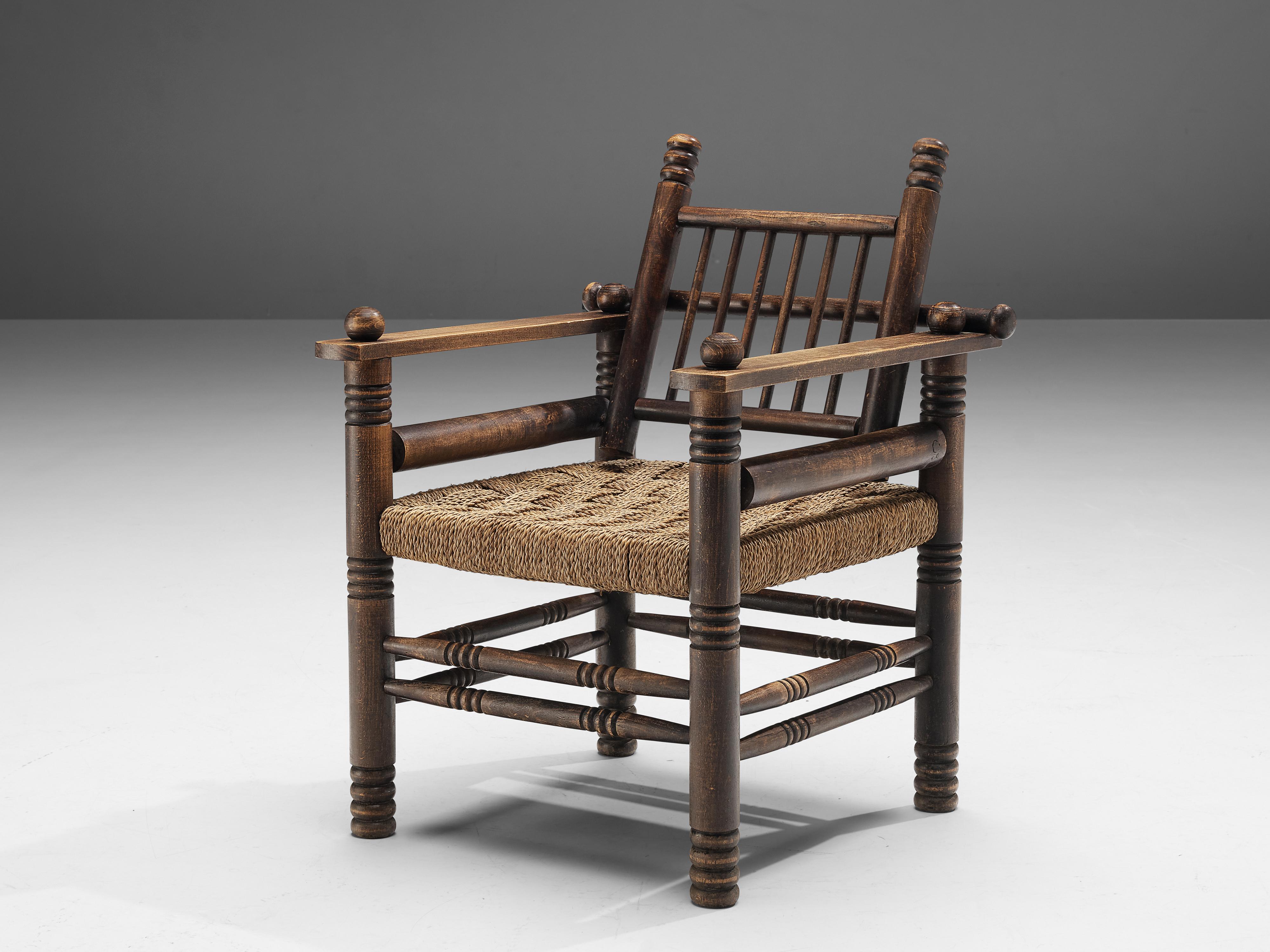 Charles Dudouyt, lounge chair, oak, paper cord, France, 1940s

Decorative lounge chair by Charles Dudouyt. The frame has multiple carved details that add up to a complex whole. Carved lines and circular ends, straight and round parts come together