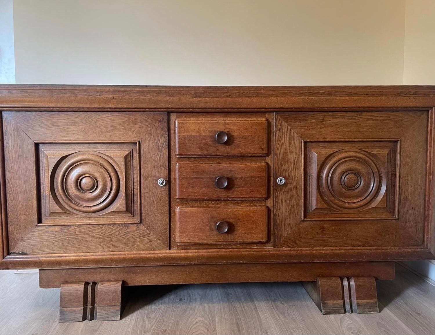 An oak with 2 doors and draws sideboard by Charles Dudouyt.