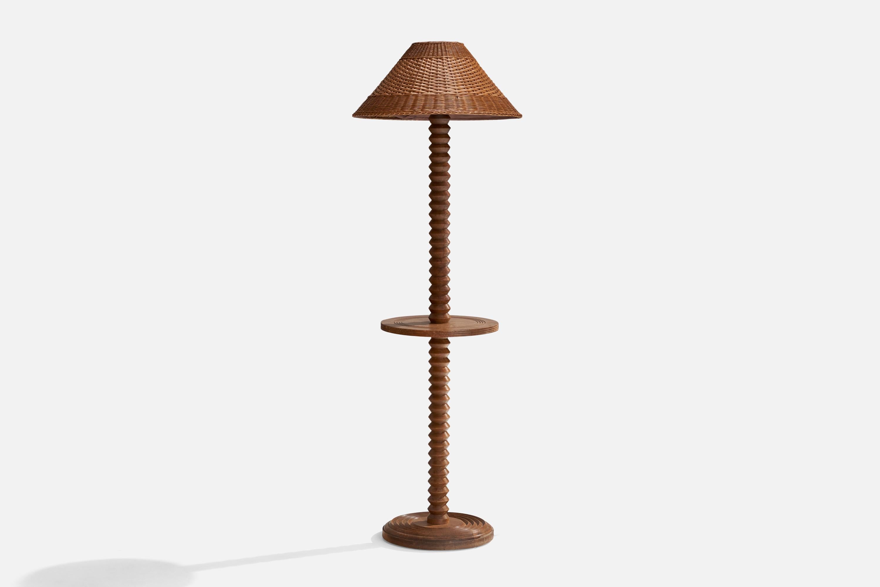 A dark-stained oak and rattan floor lamp or lamp table attributed to Charles Dudouyt, France, c. 1940s.

Overall Dimensions (inches): 64.25” H x 22” W x 21.5” D
Stated dimensions include shade.
Bulb Specifications: E-26 Bulb
Number of Sockets: 1
All