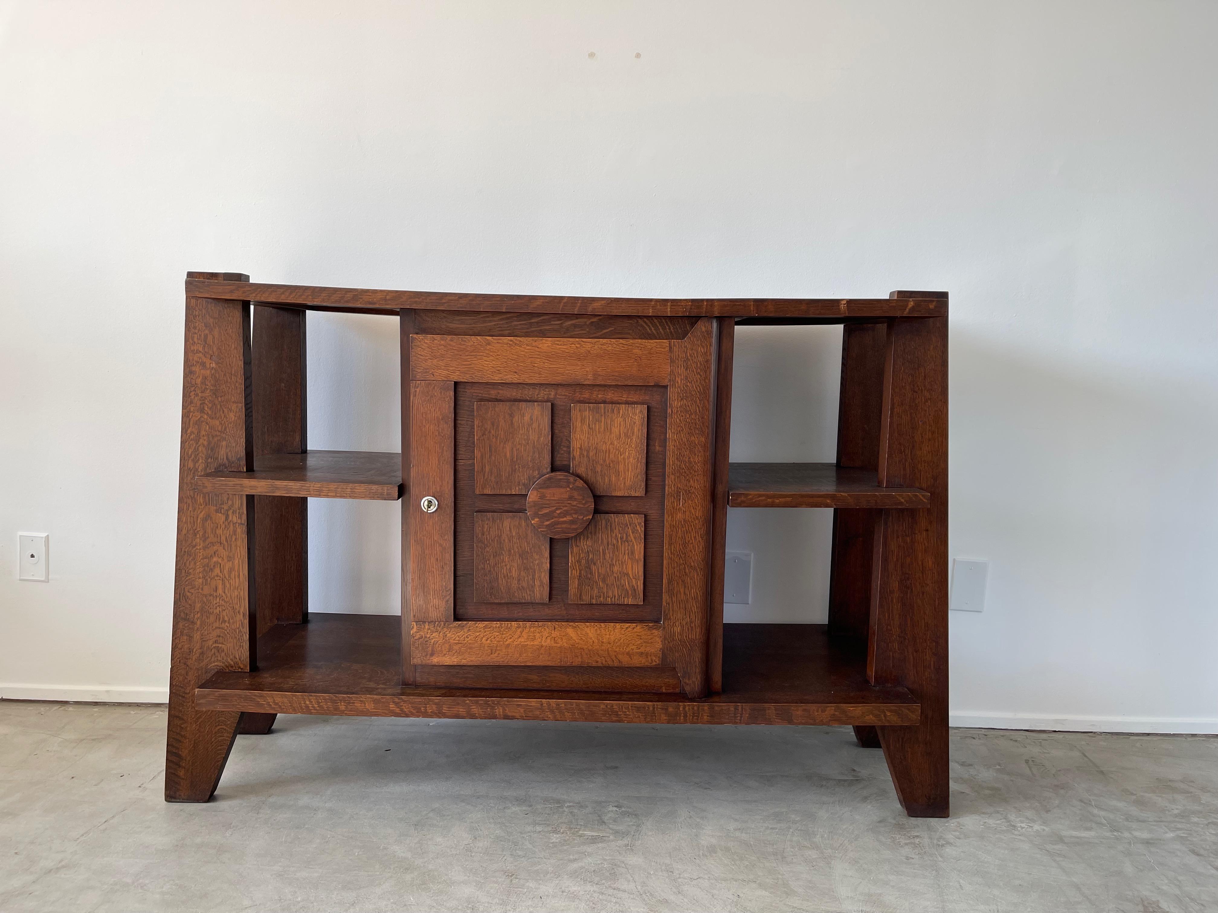 Charles Dudouyt cabinet with angular legs and open shelving.
Wonderful patina and function. 
 