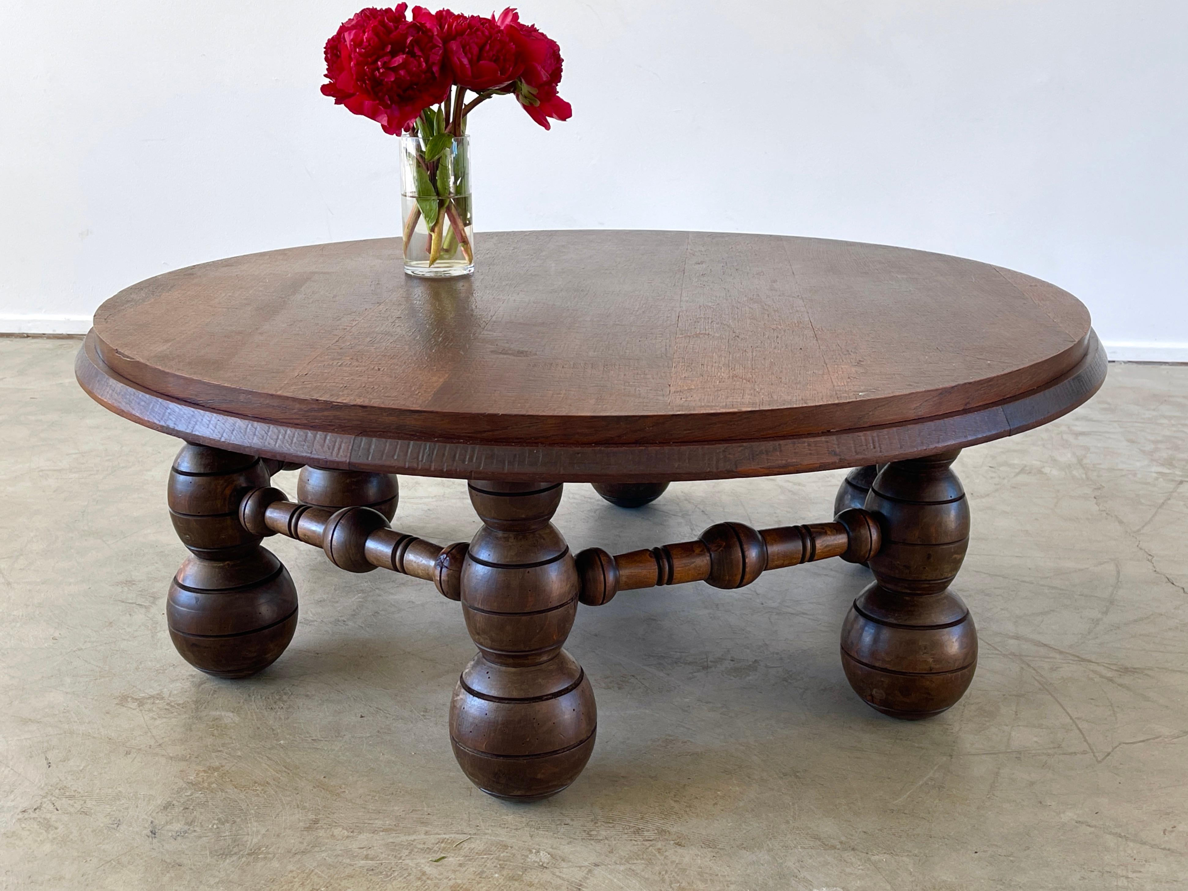 Charles Dudouyt coffee table with signature bulbous ornate legs. 
Wonderful rich patina to wood and large in scale. 
 