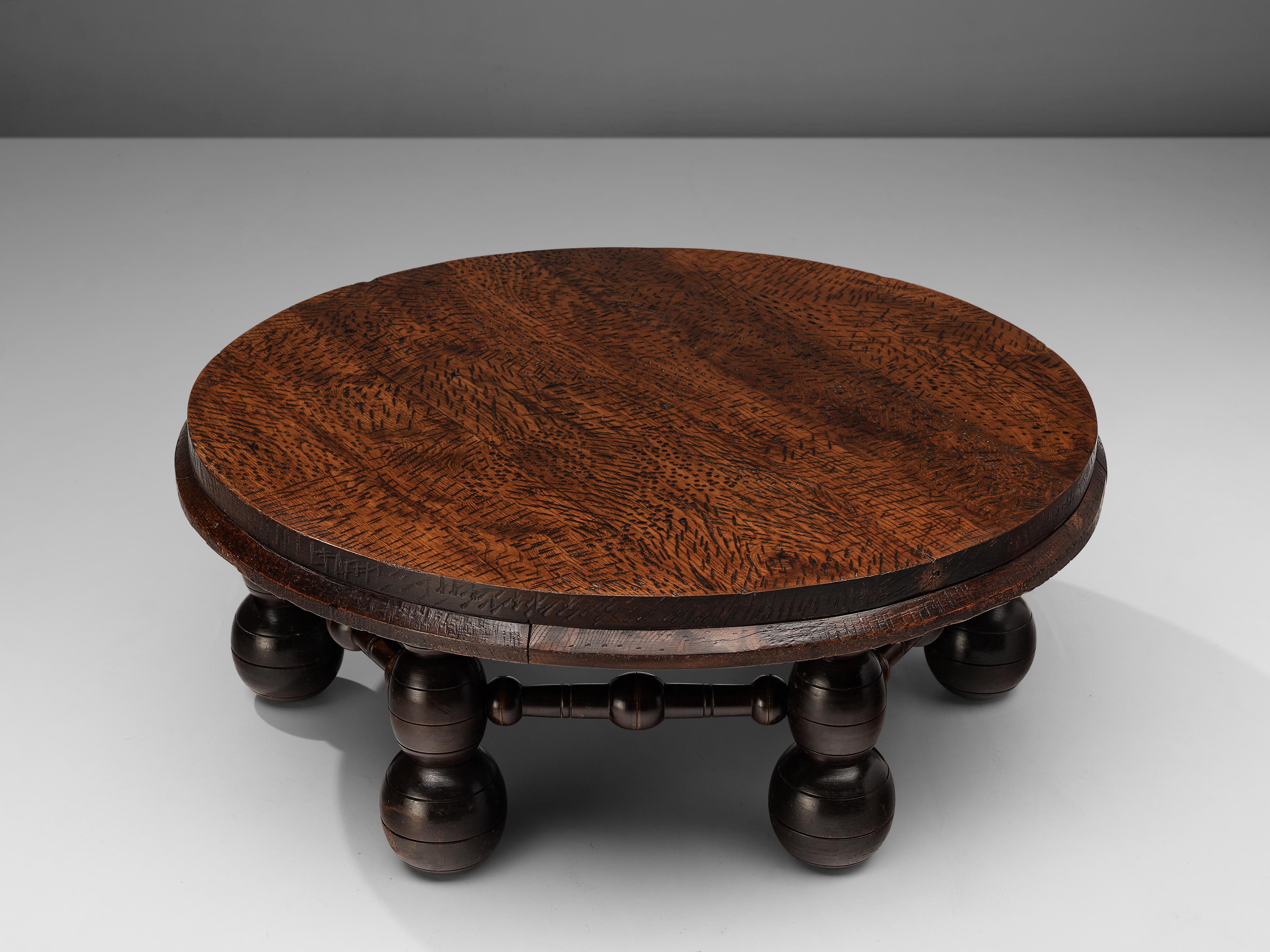Side table, darkened oak, France, 1930s

This robust side table is attributed to French designer Charles Dudouyt (1885-1946), and is made from dark stained solid oak. The round tabletop is chiselled with small cuts and dots. The signature ball feet,