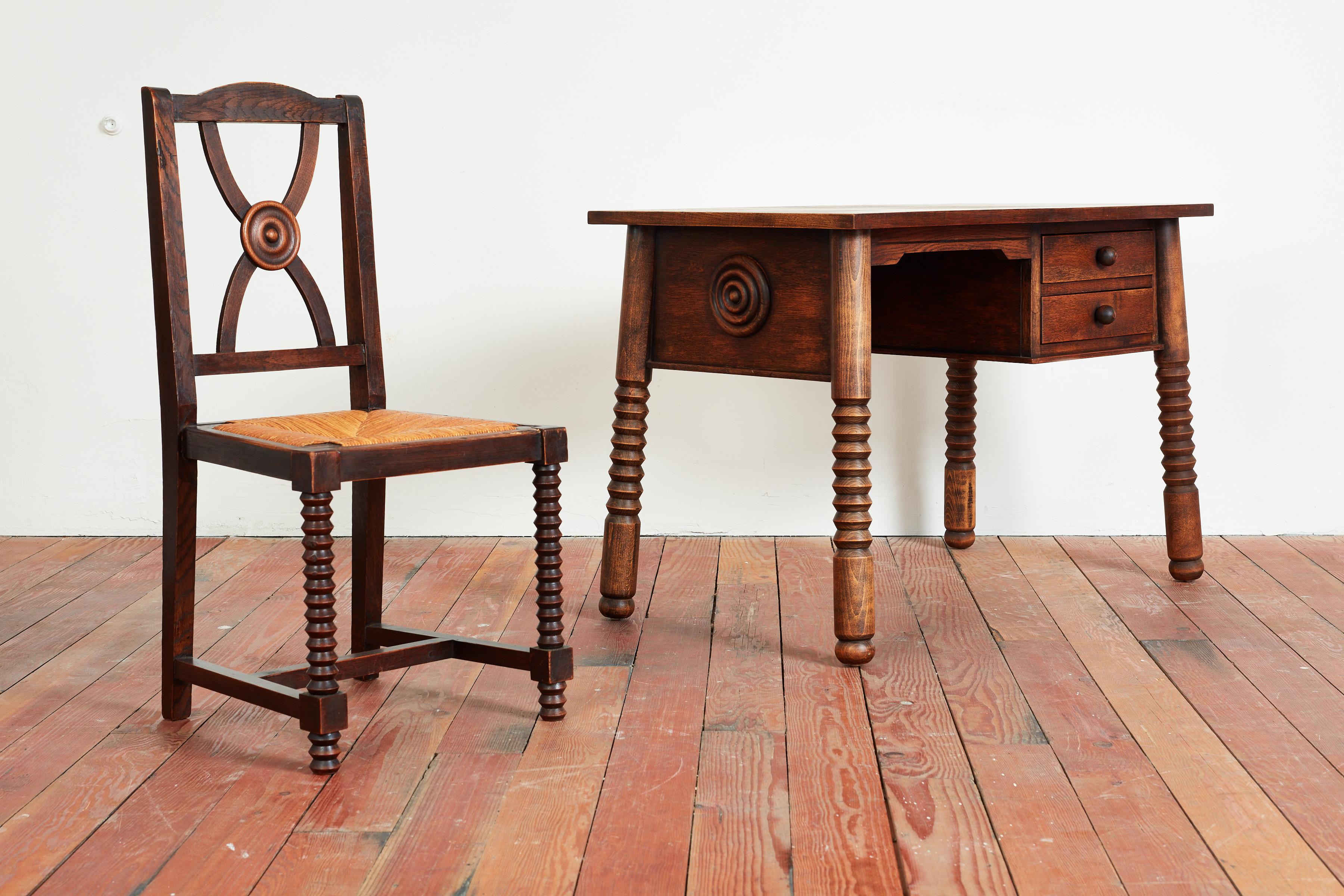 Incredible Charles Dudouyt desk and chair with signature corkscrew carved legs, checkerboard wood top and carved circular detailed sides. 

Great small desk with matching chair. 

Wonderful patina to oak

Desk measurements:
29 3/4” H x 44 3/8”W x