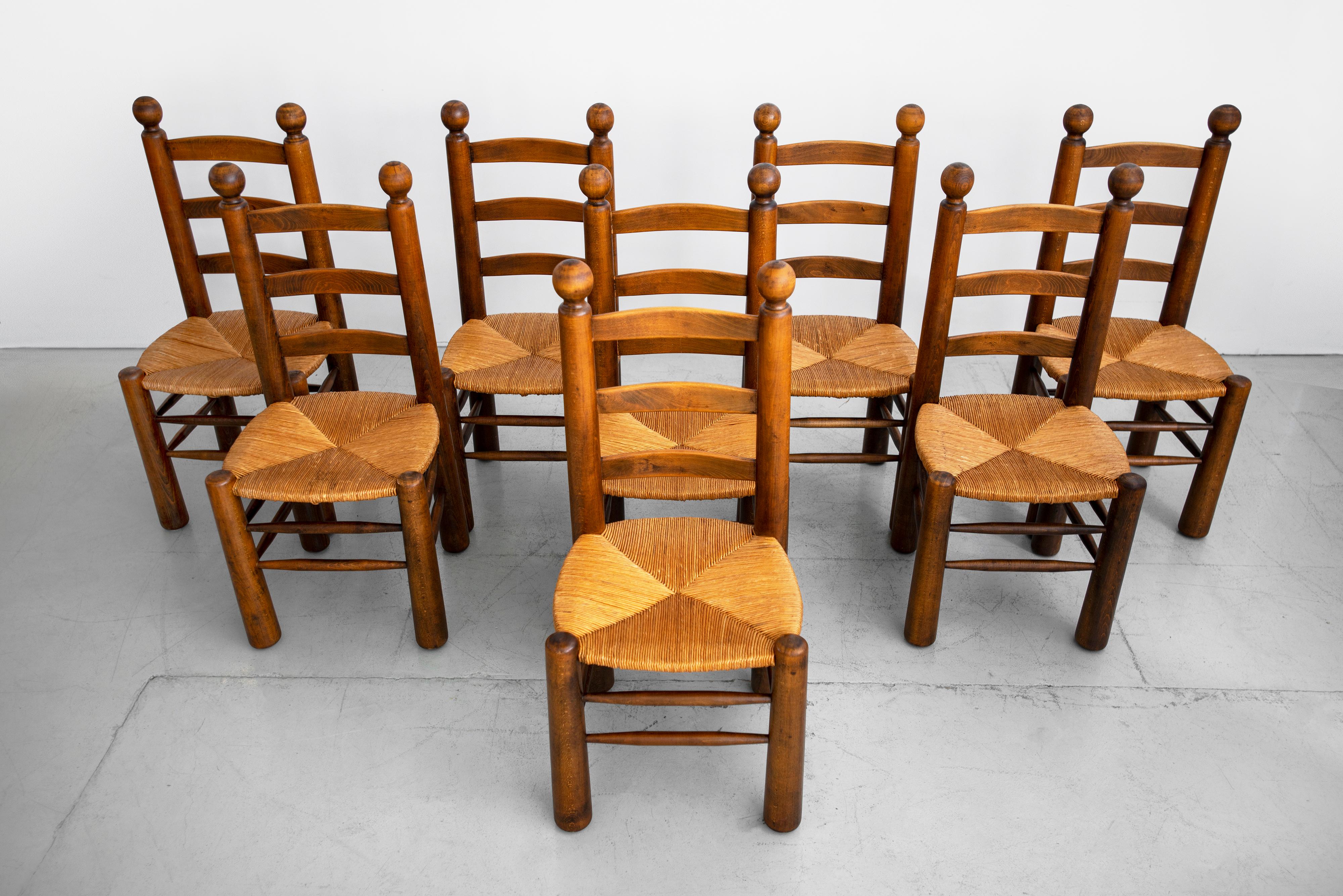 Set of 8 French dining chairs by Charles Dudouyt. Beautiful natural oak frames with woven seats. Solid and sturdy.