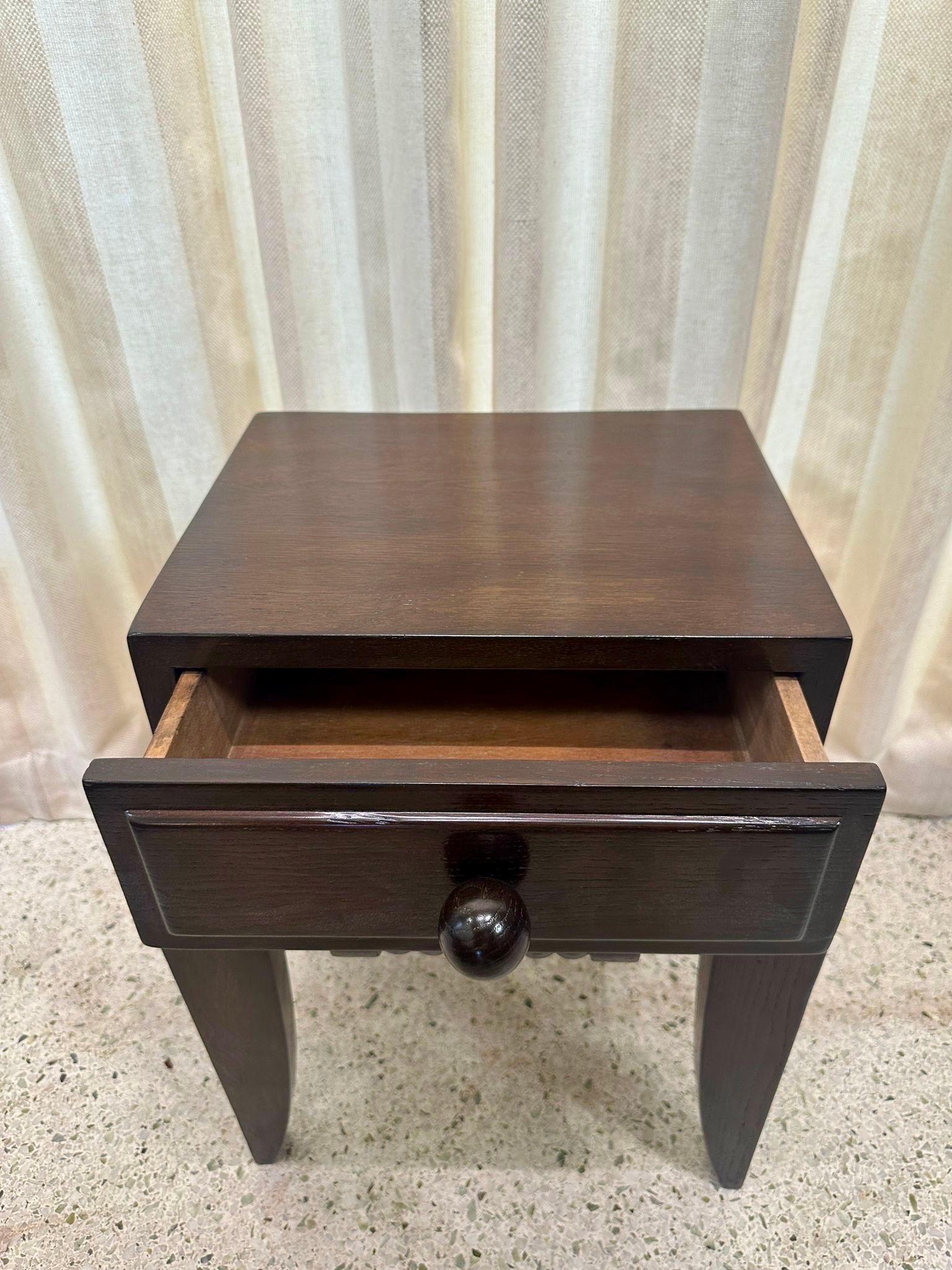 This is a whimsical small scale side table with single drawer and orb pull.  Charles Dudouyt classic Deco design, French 1940's.  Ebonized oak with tapering legs.