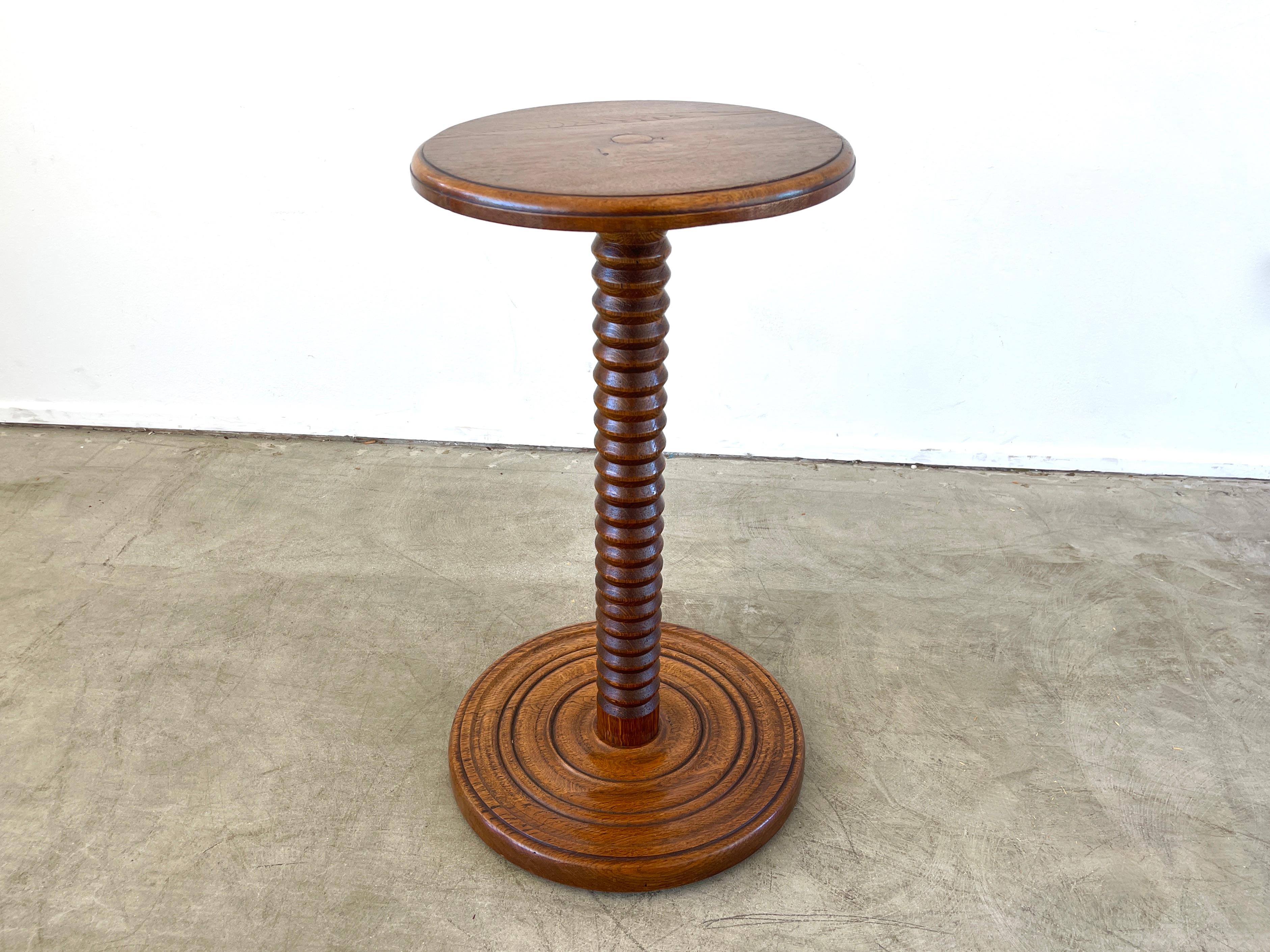 Charles Dudouyt side table with signature carved pedestal and circular base
France, 1940's.