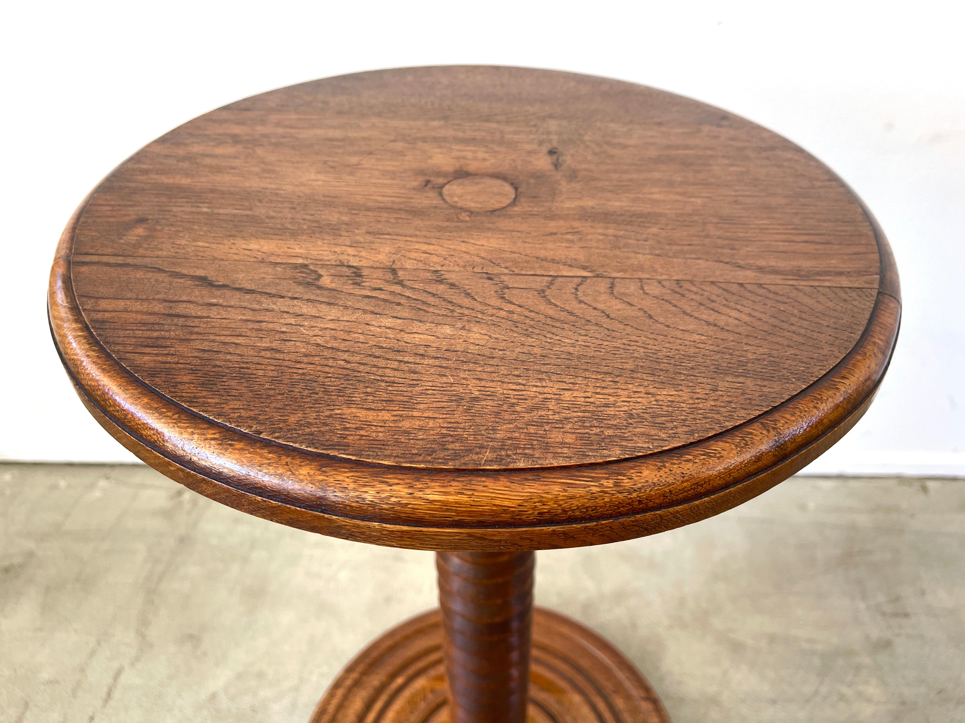 Charles Dudouyt side table with signature carved pedestal and circular base
France, 1940s.