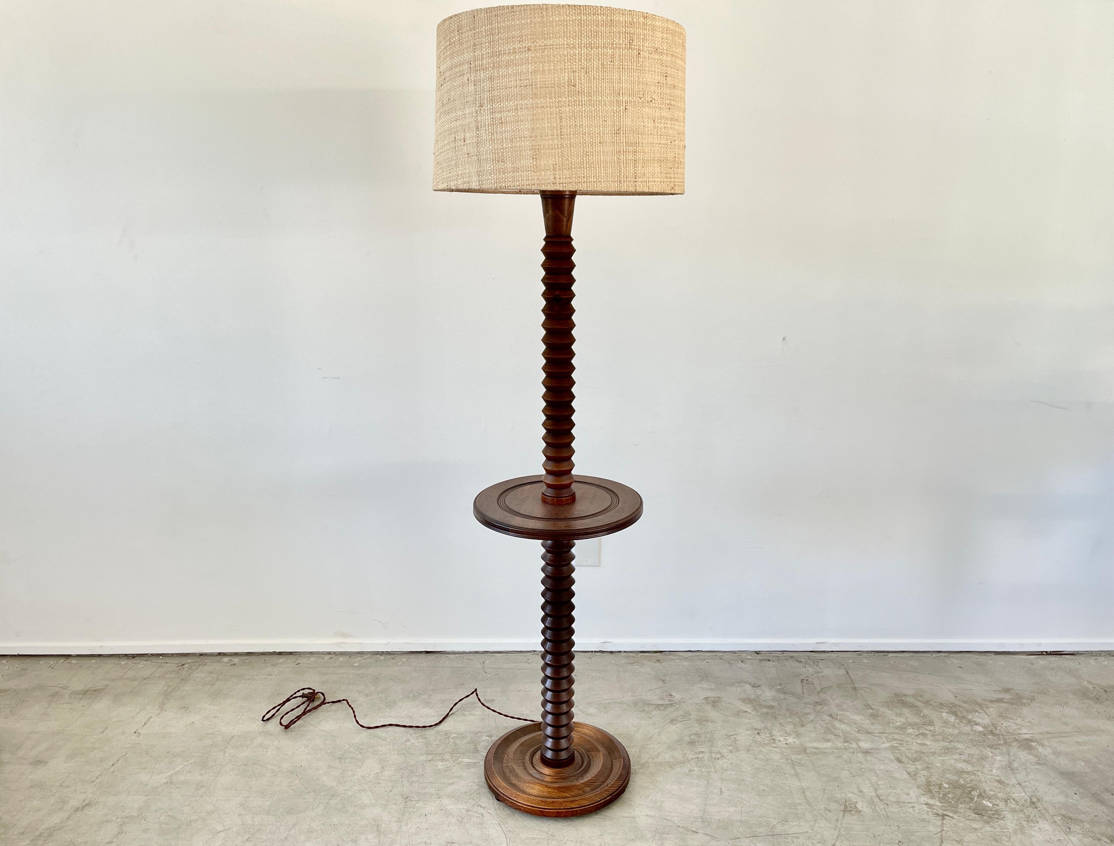 Charles Dudouyt attributed floor lamp with signature corkscrew base and floating table with carved concentric circles. 
Newly rewired and shade.