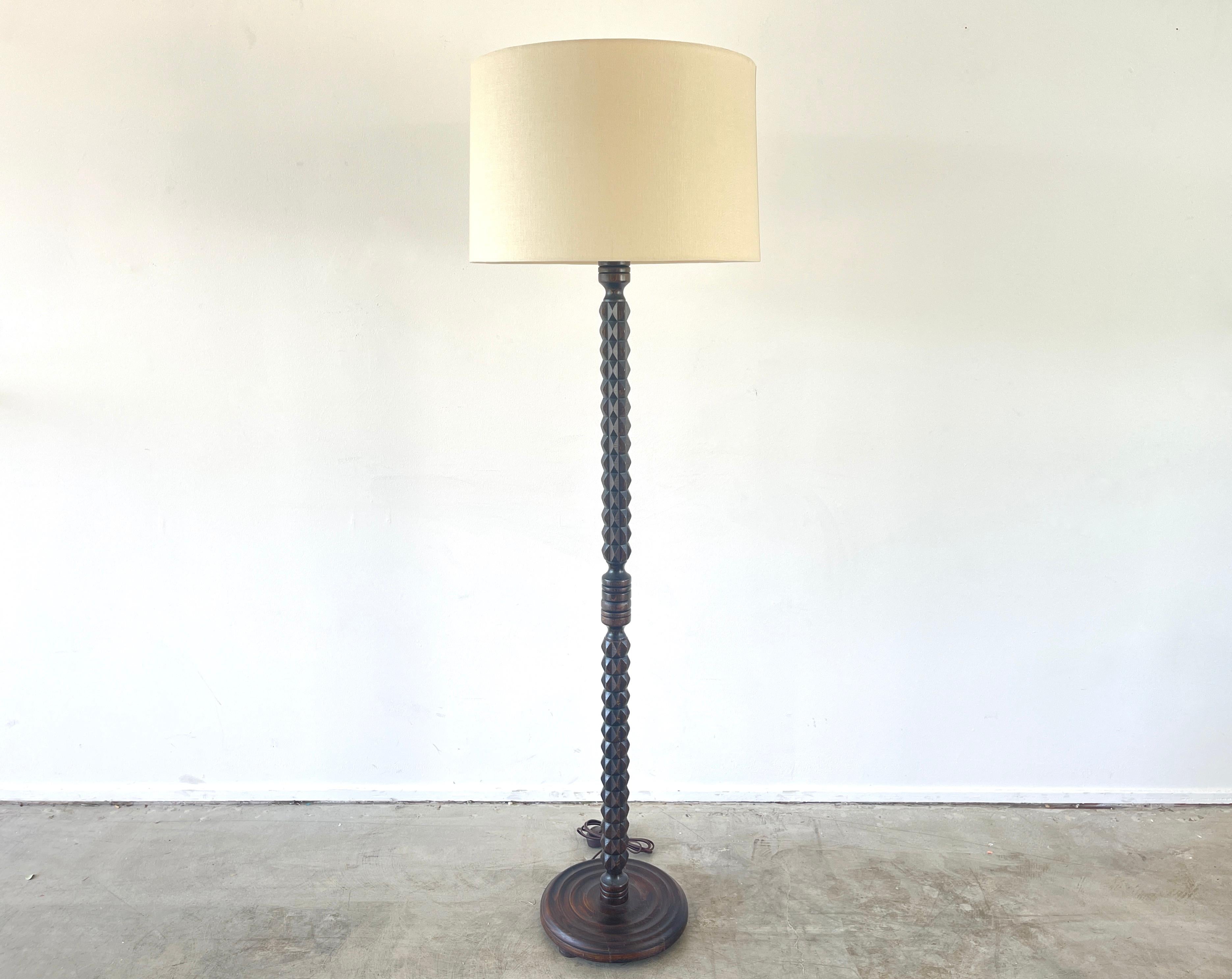 Charles Dudouyt table lamp, circa 1940's 
Intricately carved wood design with concentric circled base.
Newly rewired and new shade.