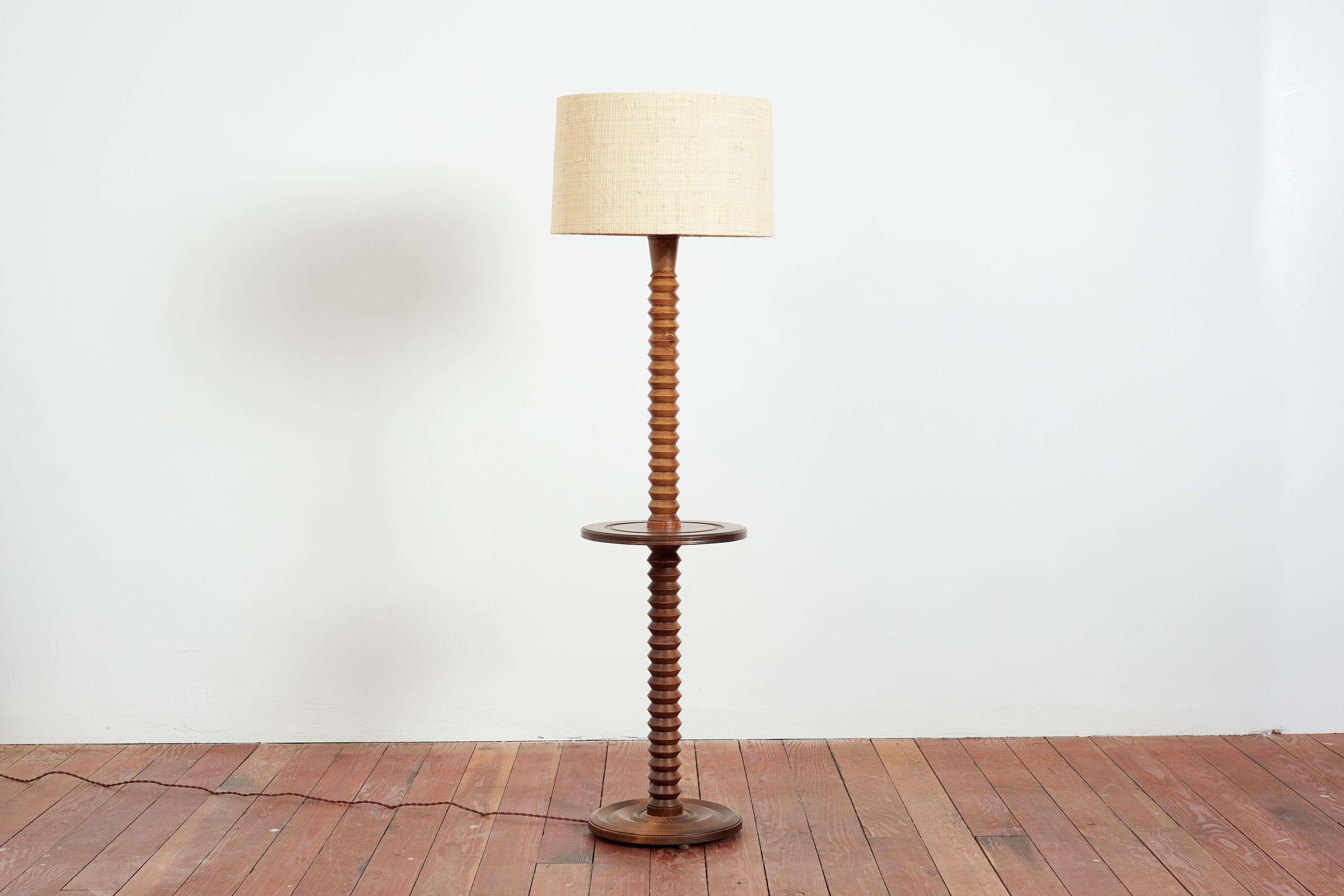 Charles Dudouyt oak floor lamp with signature corkscrew base with floating table. 

Concentric carved circle design on base as well as table.

Newly rewired and new rafia shade 