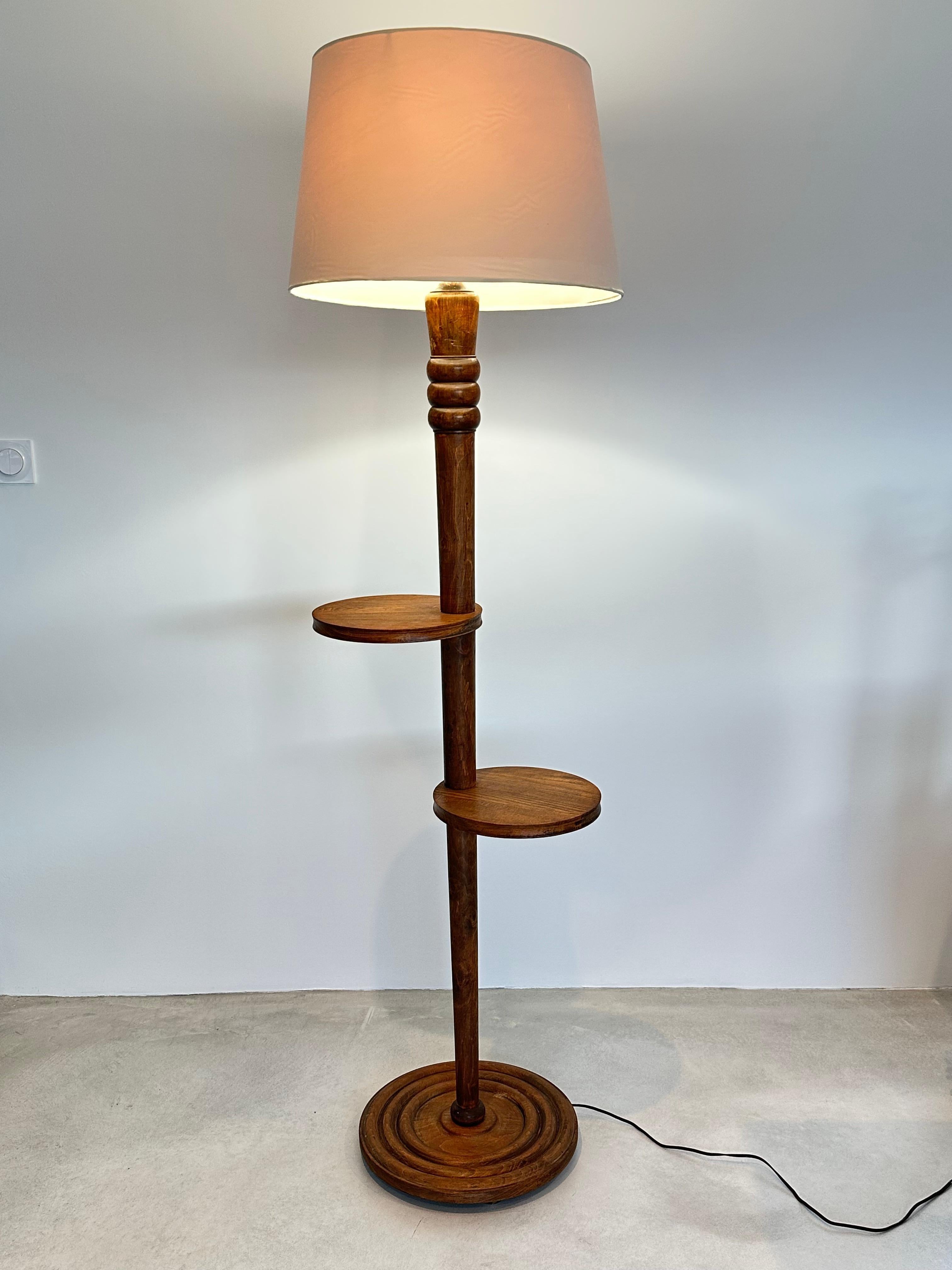 Charles Dudouyt attributed floor lamp.

Created during the rustic chic period of the 1940s, this floor lamp is elegant and quality made.

Solid Walnut with spindle structure with 3 sculpted rings at the top, circular base with carved concentric