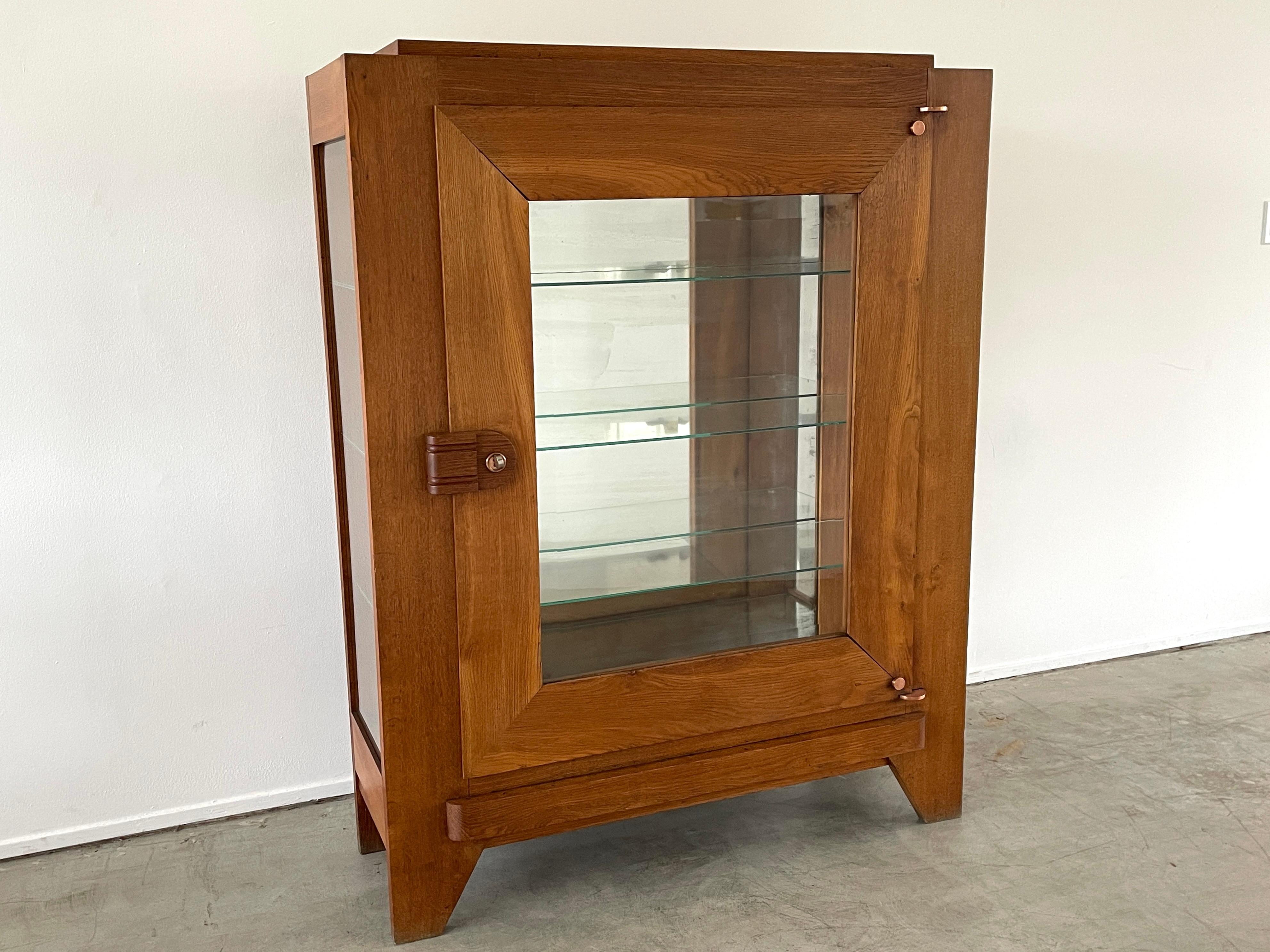 Great vitrine cabinet by Charles Dudouyt with glass sides and shelves 
Wonderful patina to wood.