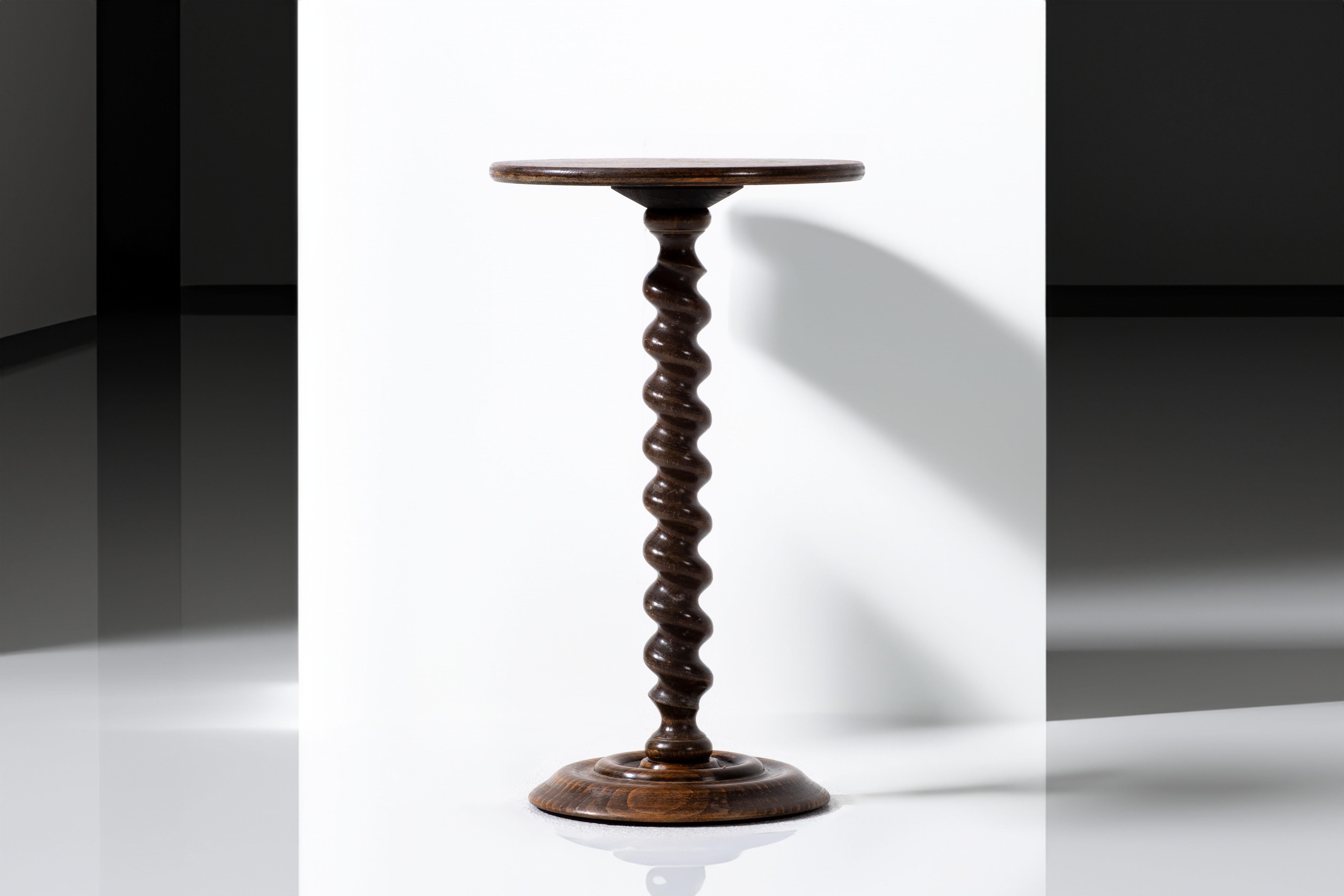 Introducing a delightful French vintage end table or gueridon, inspired by the unmistakable style of renowned designer Charles Dudouyt. This charming piece showcases a signature wine press screw leg design, expertly crafted from oak, paying homage