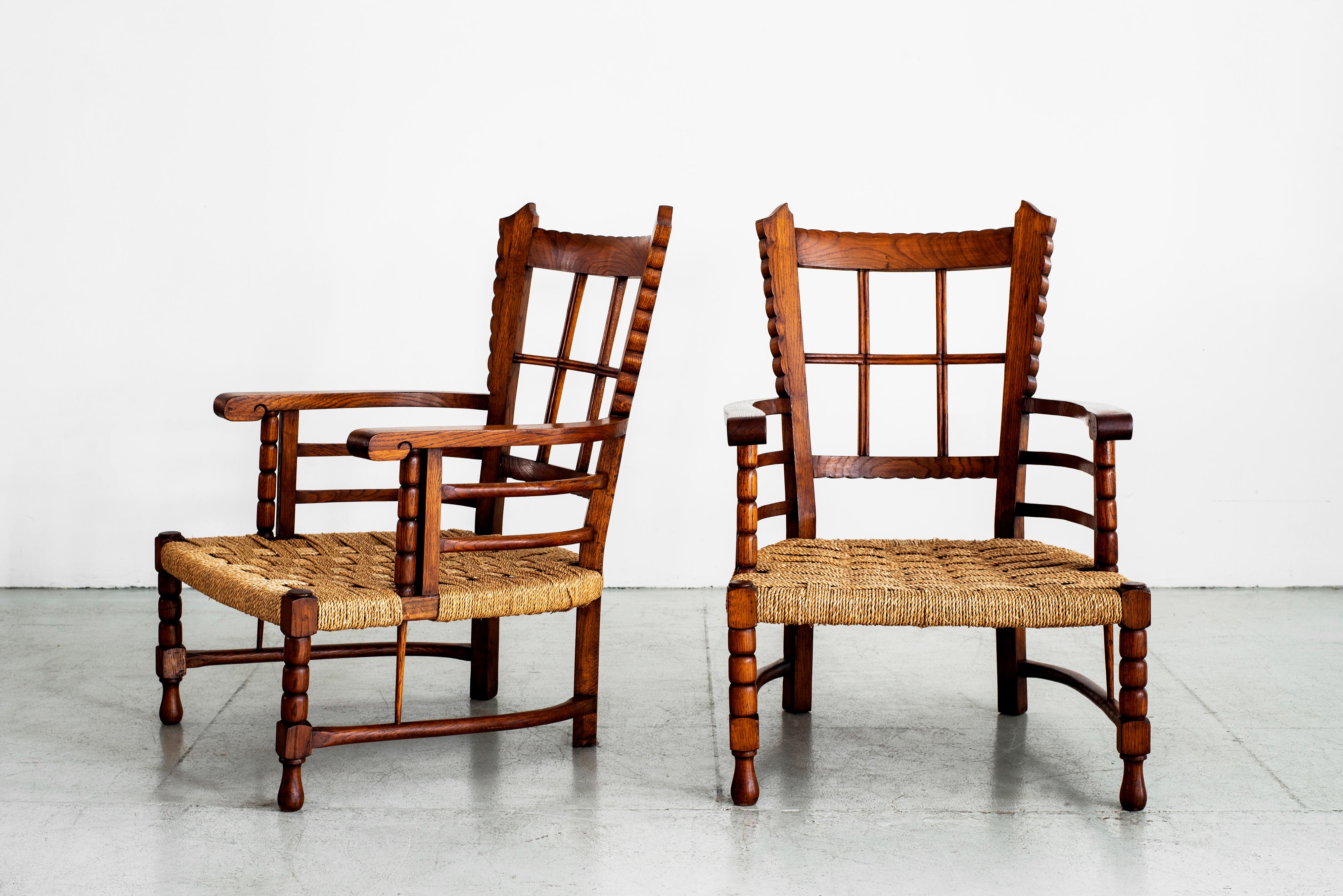 Fantastic pair of Charles Dudouyt chairs with low rushed seats and beautiful carved oak
Scalloped carved edges throughout the chairs with ornate detail.
  