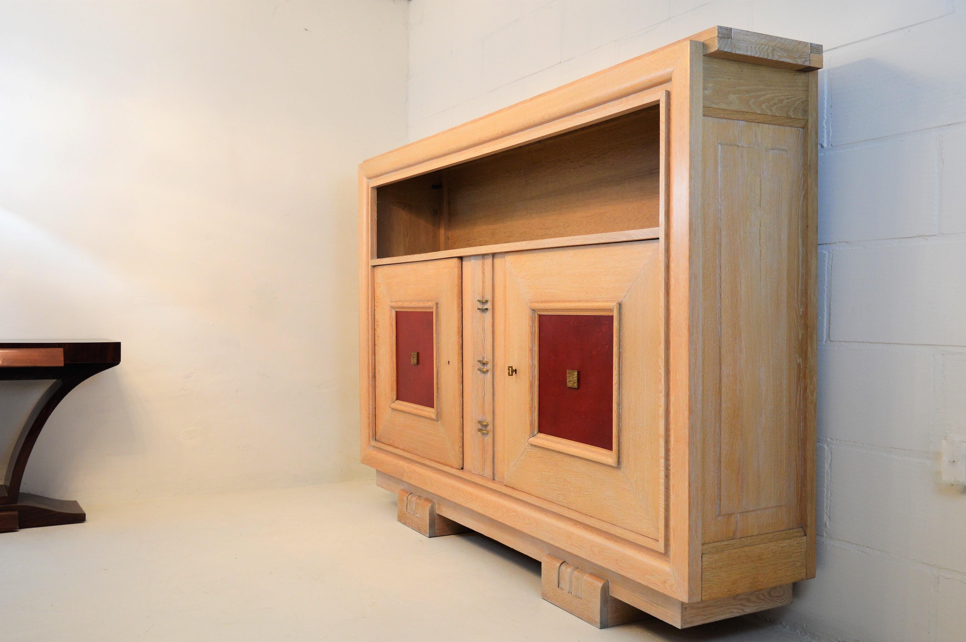 French Charles Dudouyt Masterpiece Oak Cabinet, with Doorpanels Covered in Red Leather