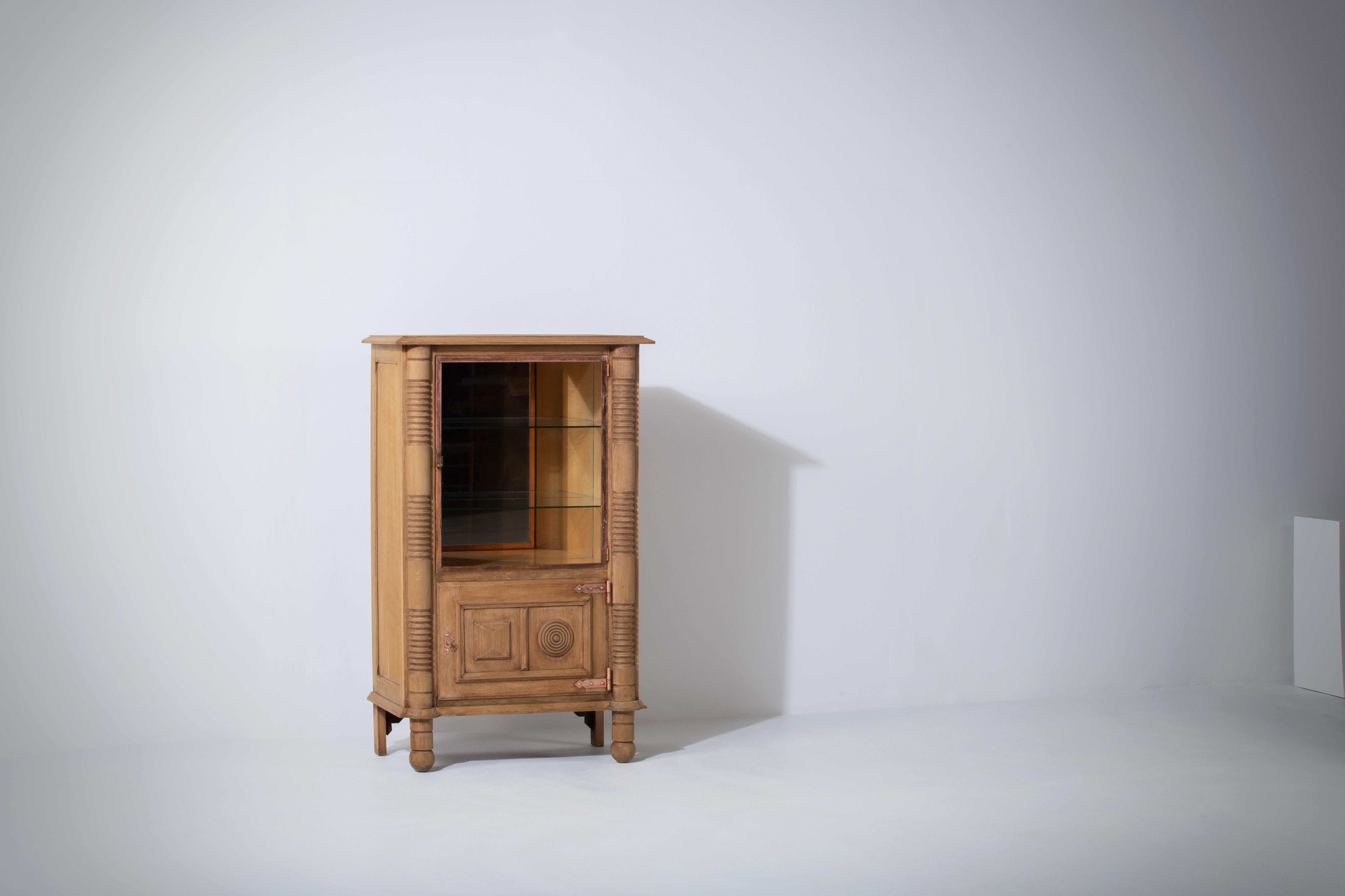 Raw oak sculpted cabinet by Charles Dudouyt in a bleached finish.
France c. 1950.
