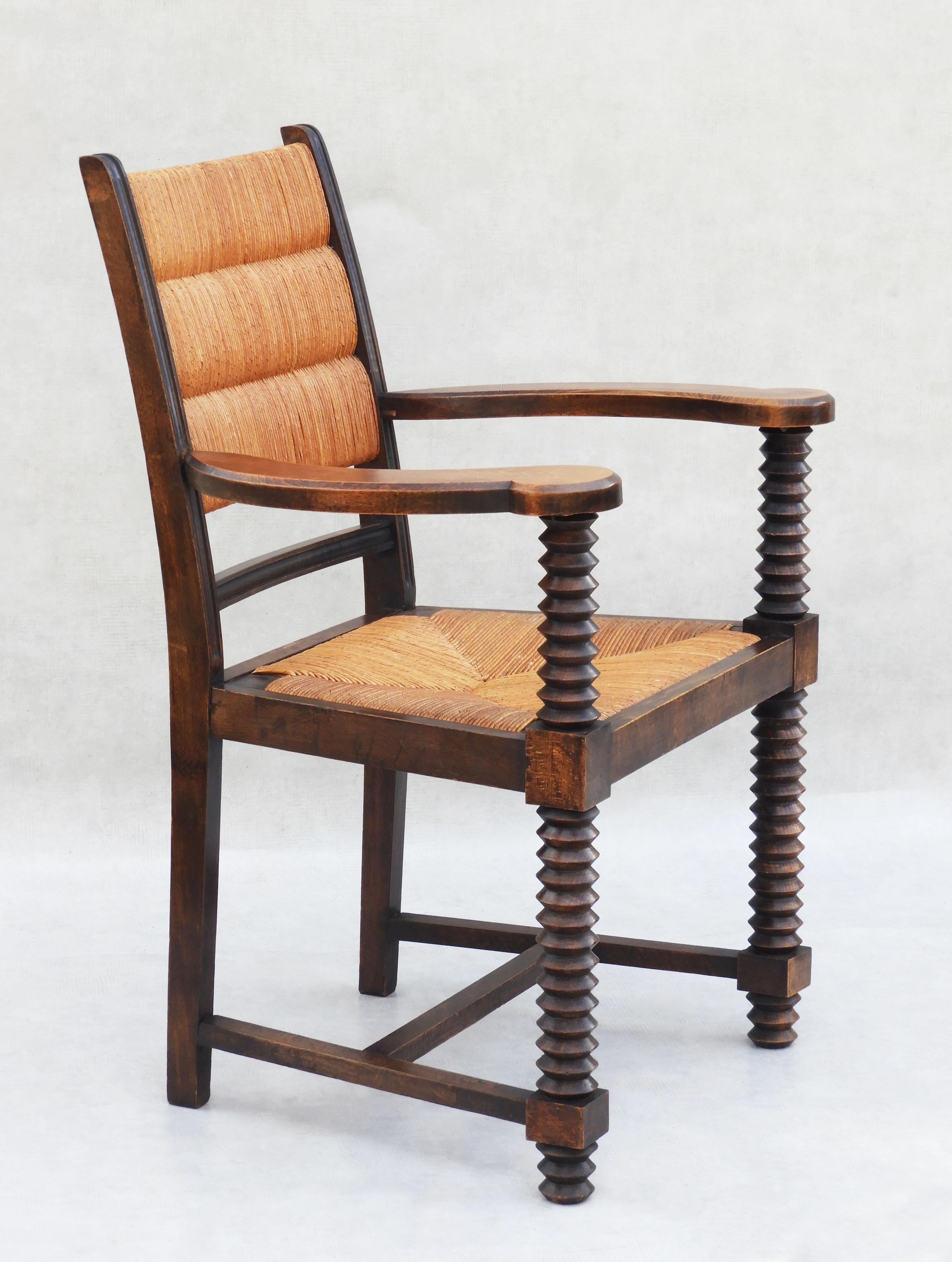 Fabulous oak and rush back and Armchair, by Charles Dudouyt C1940           
Great design and good craftsmanship. All original carved oak frame, signature wine press screw legs, distinctive woven rush work back and seat. In good vintage condition,