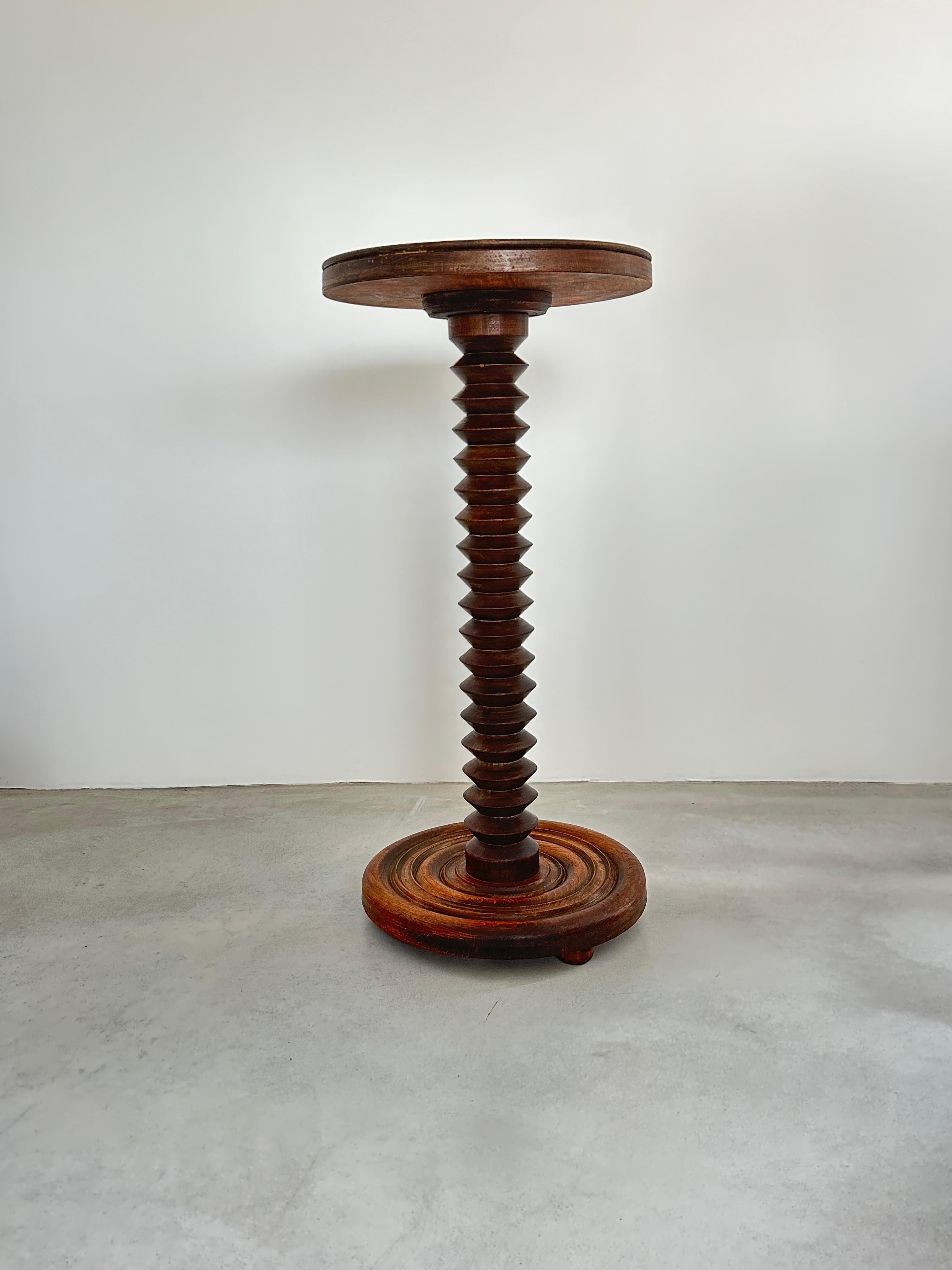 Elegant oak side table or pedestal created by Charles Dudouyt.

Beautiful rustic chic French design.

Circular base and top, diameter 15.74 inch / 40 cm.
Turned wooden body.
Table height 31.9 inch / 81 cm

The wood has been treated and waxed by a