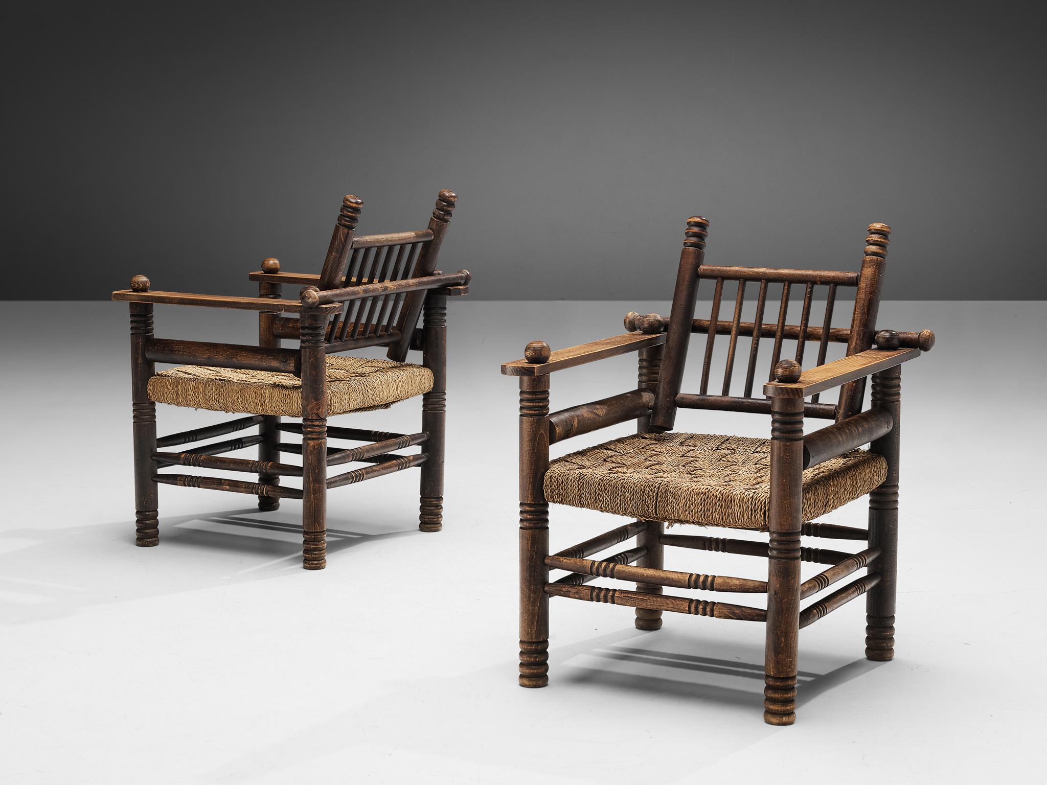 Charles Dudouyt, pair of lounge chairs, poplar, ash, beech, rush, France, 1940s.

Decorative lounge chairs designed by Charles Dudouyt. The frame has multiple carved details that add up to a complex whole. Carved lines and circular ends, straight