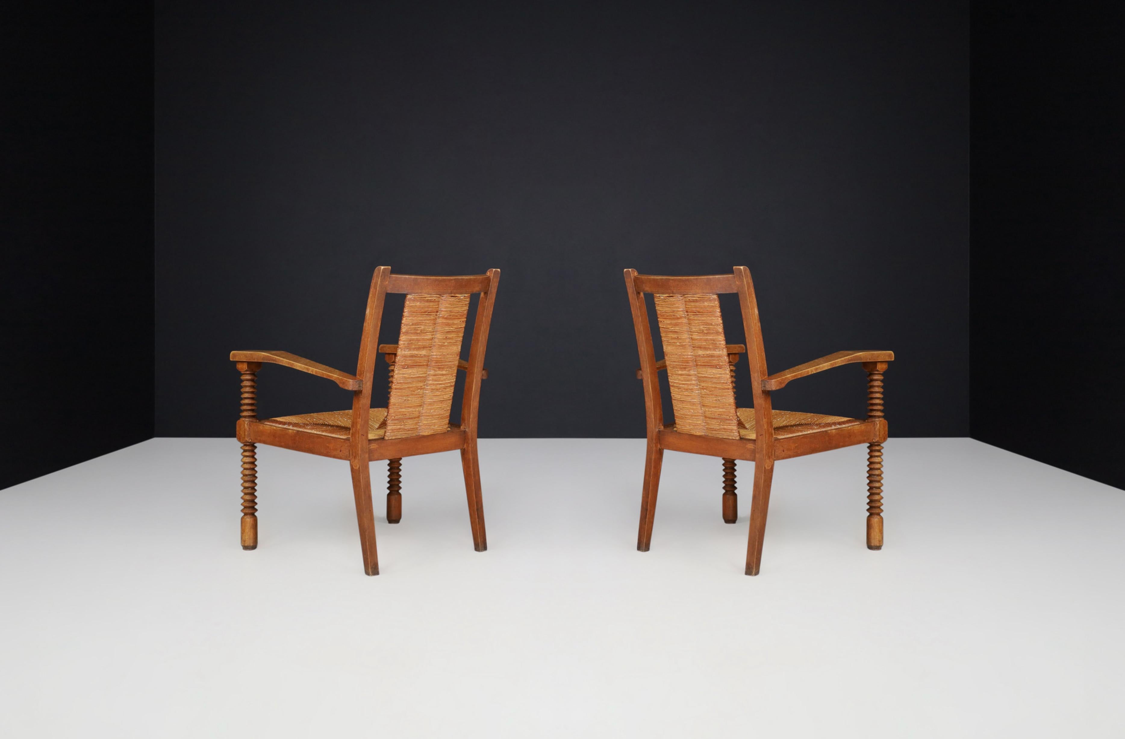 French Charles Dudouyt Patinated Oak and Rush Armchairs, France 1940s For Sale