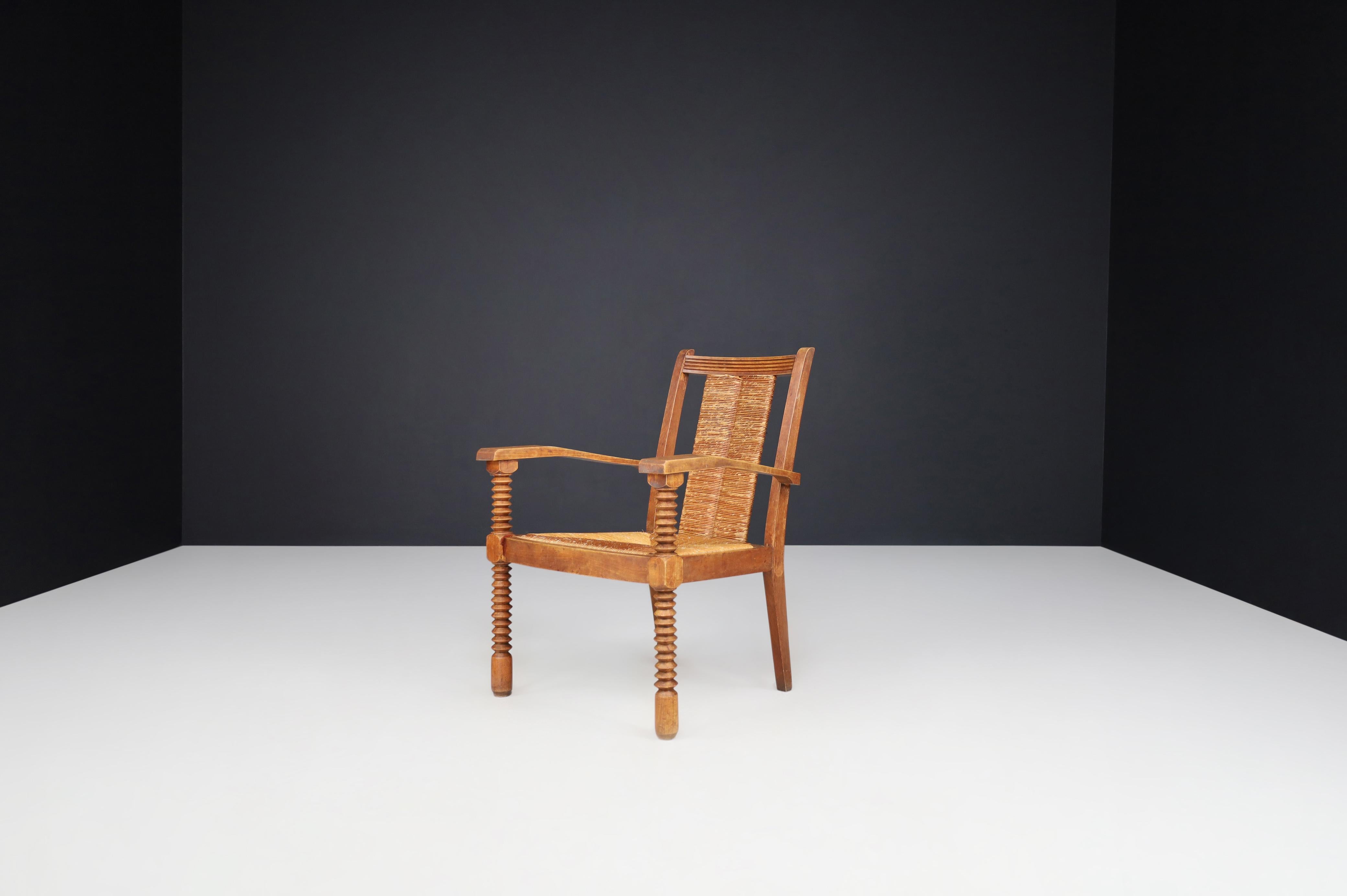 20th Century Charles Dudouyt Patinated Oak and Rush Armchairs, France 1940s For Sale